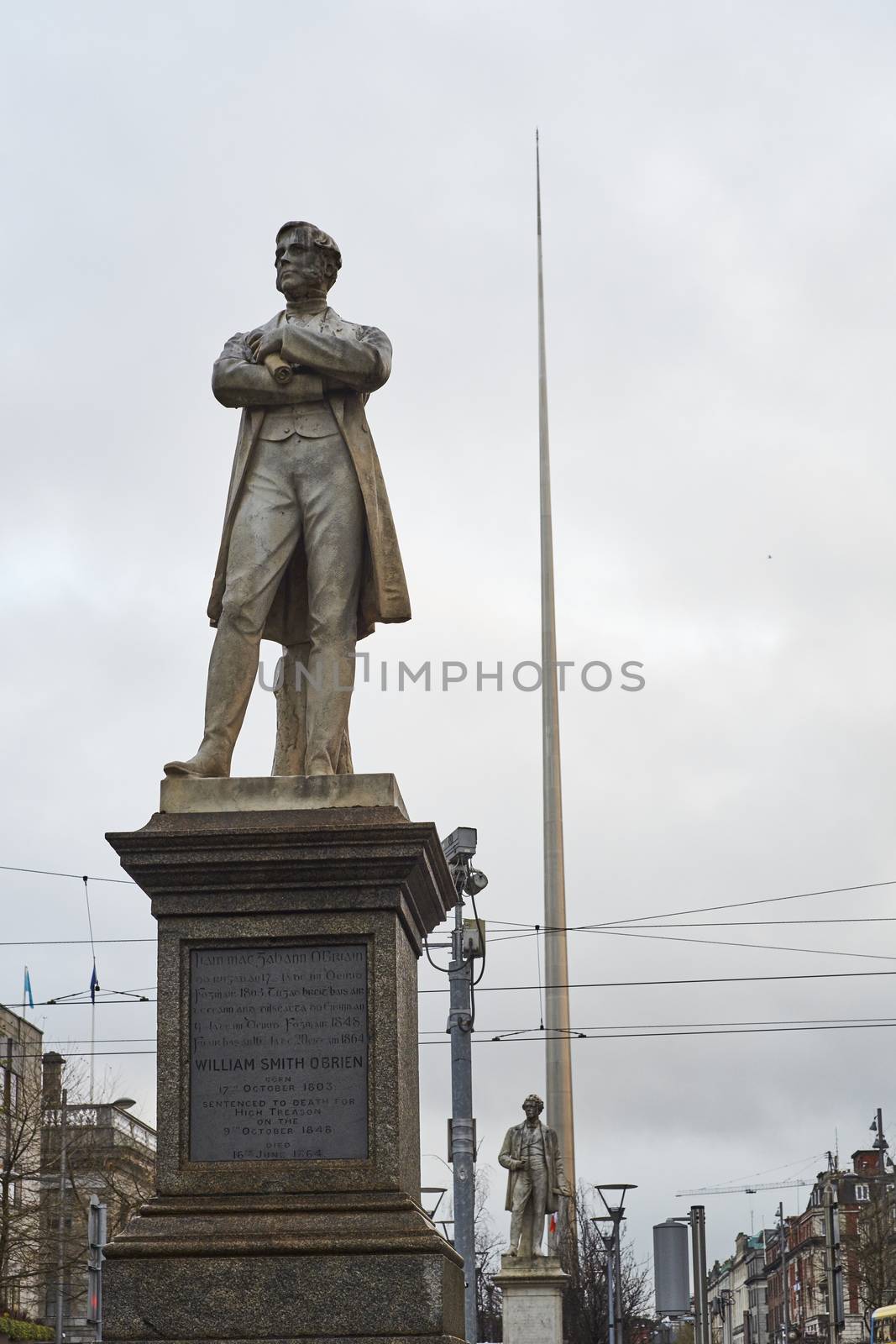 DUBLIN, IRELAND - JANUARY 05: Statue of William Smith O'Brien with Millennium Spire in the background, in overcast day. January 05, 2016 in Dublin
