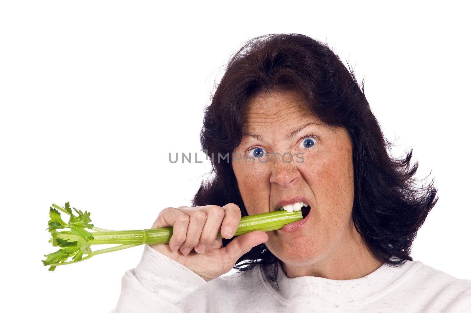 Overweight woman trying to eat healthy celery and hating it.