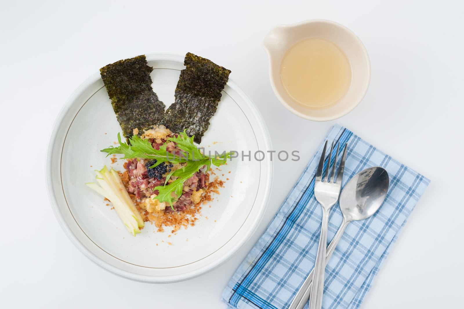 Raw dry-aged beef with herbs, seaweed and soup, Modern cuisine in Japanese style