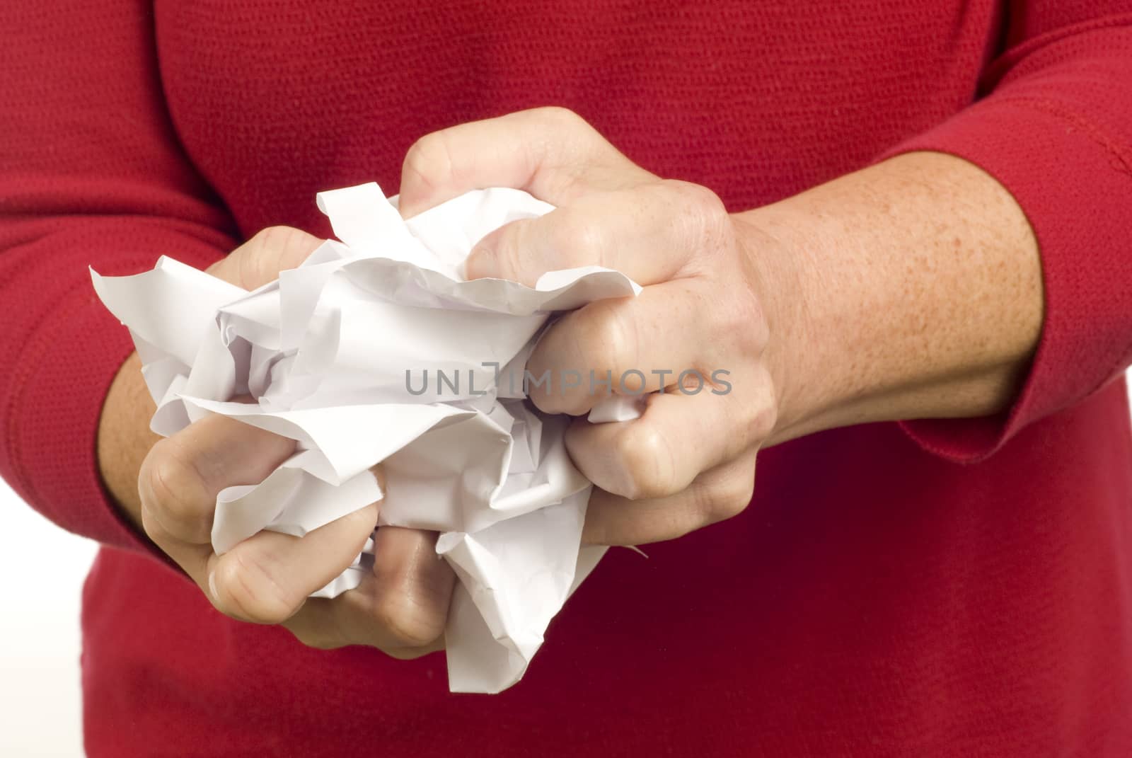 Horizontal shot of a woman crumpling paper.