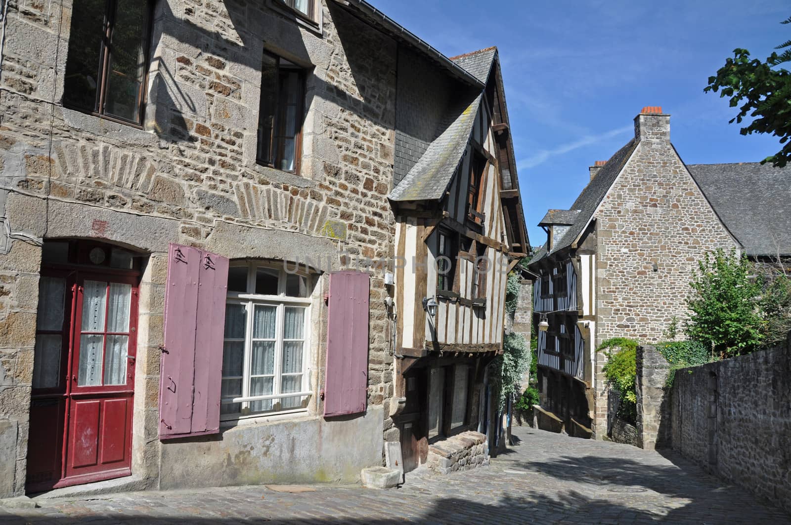 Medieval half-timbered buildings in the ancient french town of Dinan in Brittany. These old houses are in the Rue de Jerzual, which leads into the Rue du Petit Port and then to the River Rance ~ probably the street most visited by tourists