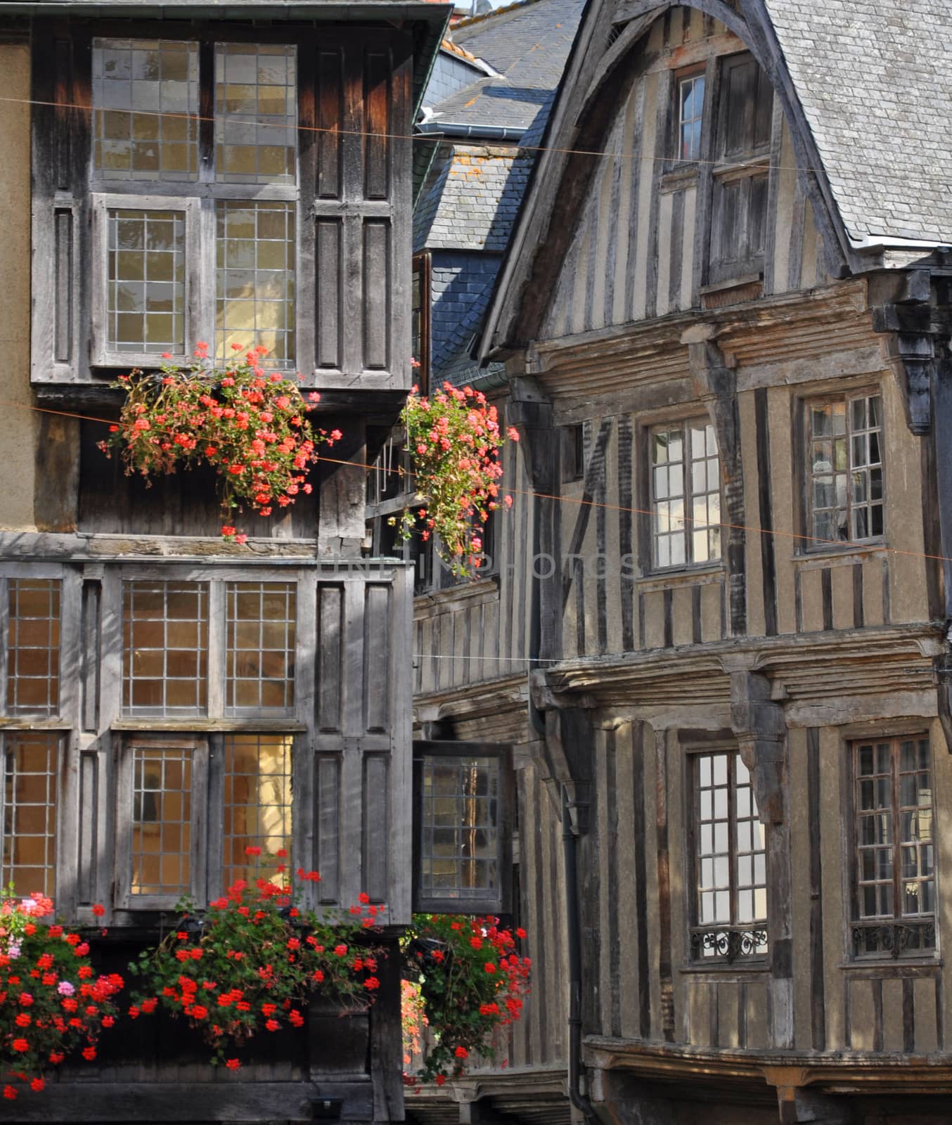 Medieval half-timbered buildings in the ancient french town of Dinan in Brittany. These old buildings are in the Place des Merciers (Haberdashers Square)~ One of  most visited by tourists