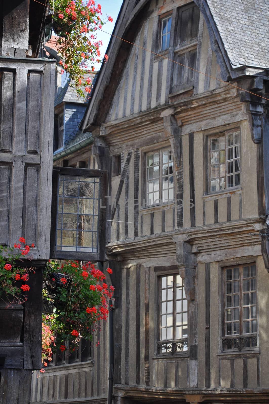 Medieval half-timbered buildings in the ancient french town of Dinan in Brittany. These old buildings are in the Place des Merciers (Haberdashers Square)~ One of  most visited by tourists