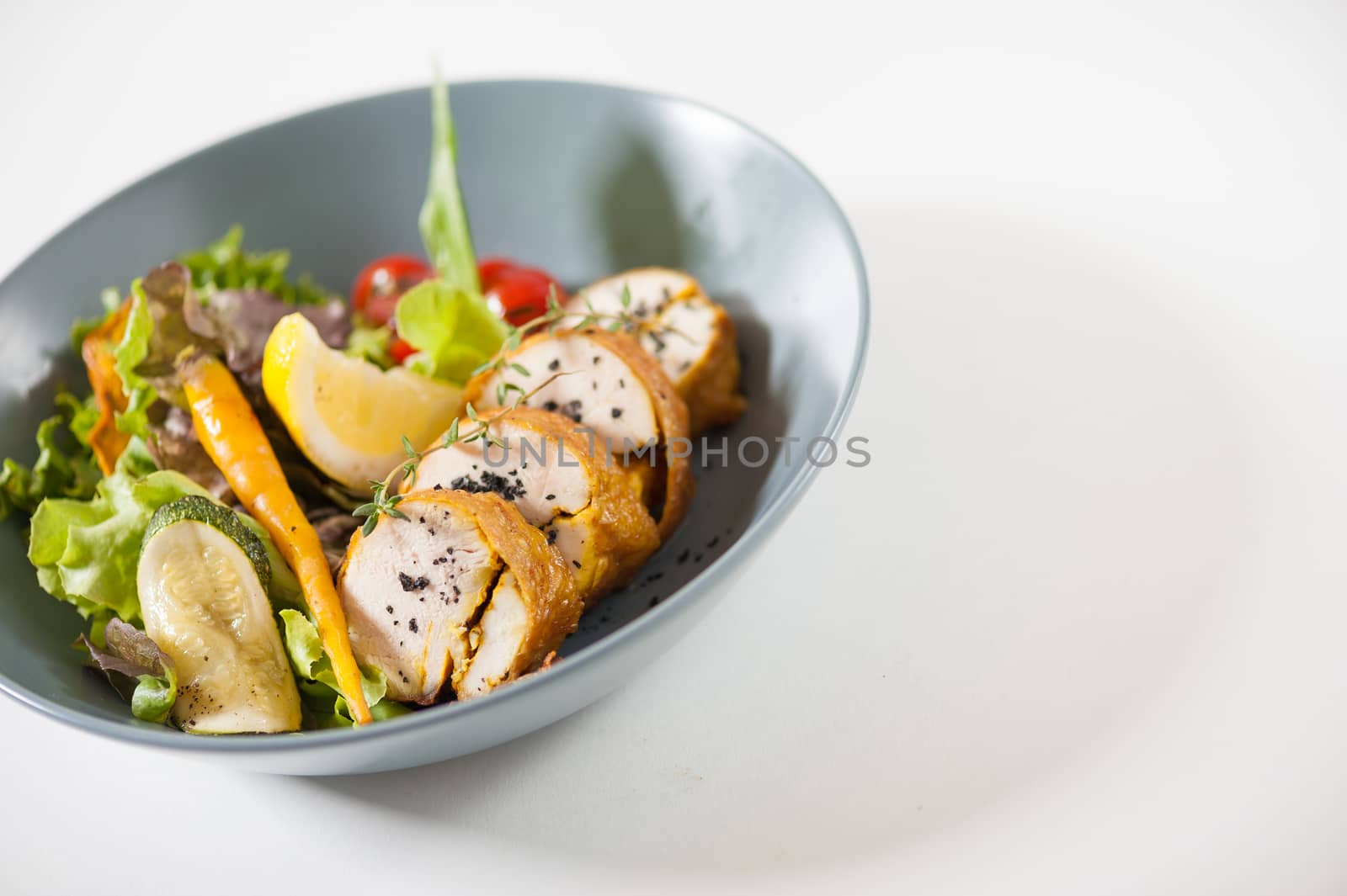 Modern style salad with roasted chicken breast roll