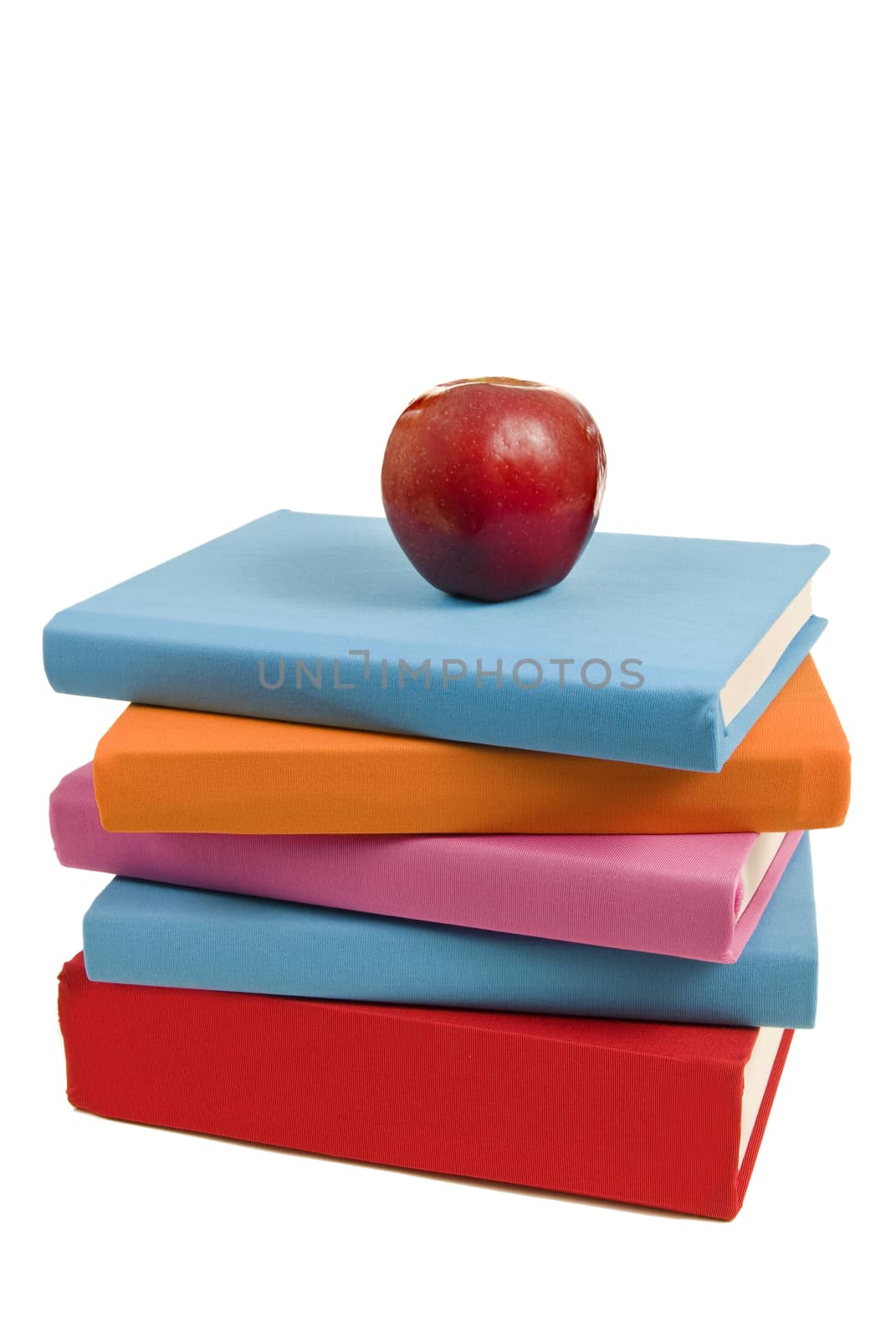 Books Stacked Unevenly With Apple by stockbuster1