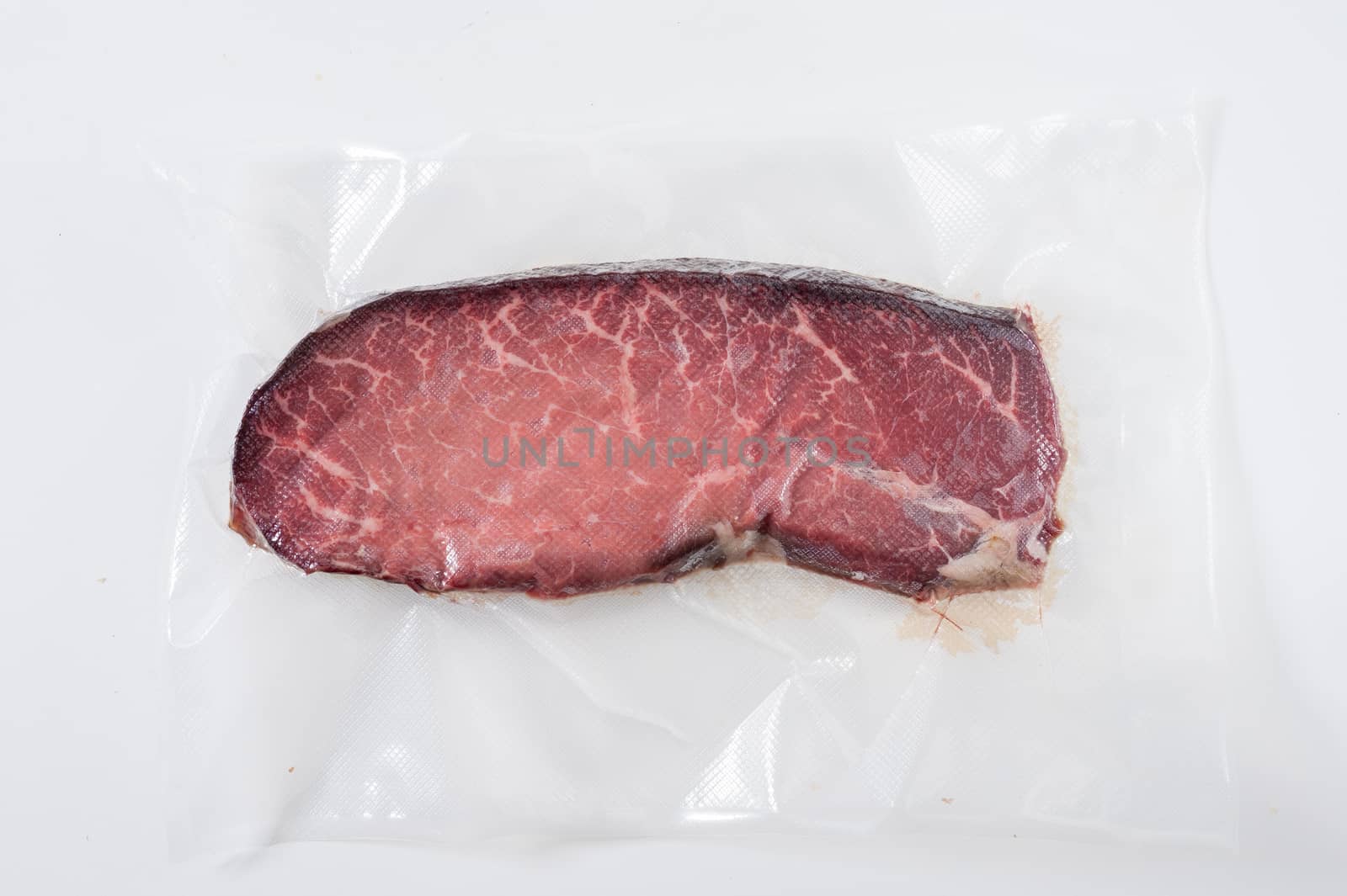 Dry-aged beef in plastic seal package