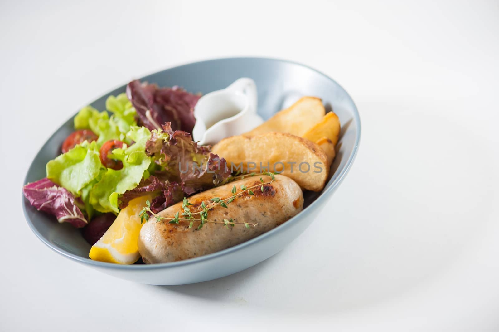 Grilled sausage with fried potatoes and salad