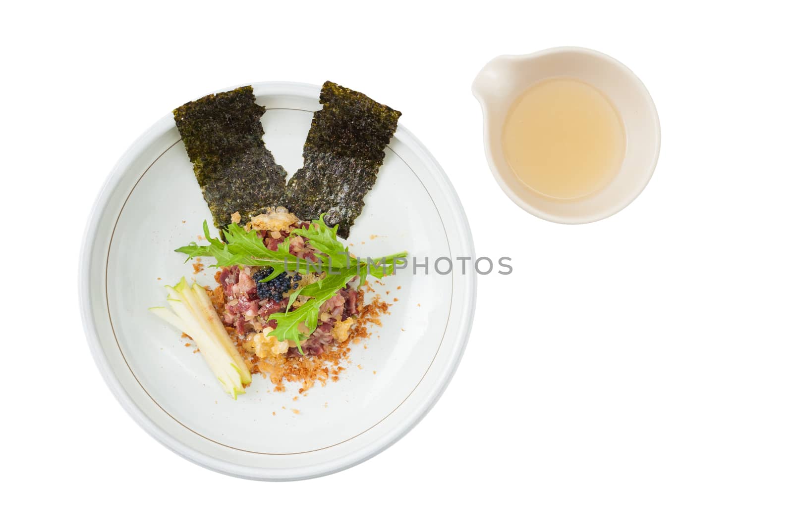 Raw dry-aged beef with herbs, seaweed and soup, Modern cuisine in Japanese style isolated on white background with clipping path