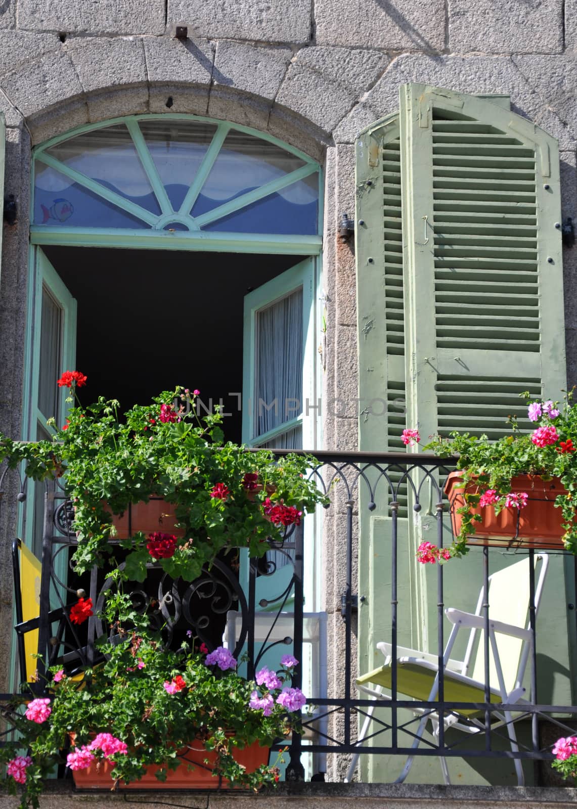 A beautiful balcony on a riverside house in the medieval town of Dinan in Brittany, France