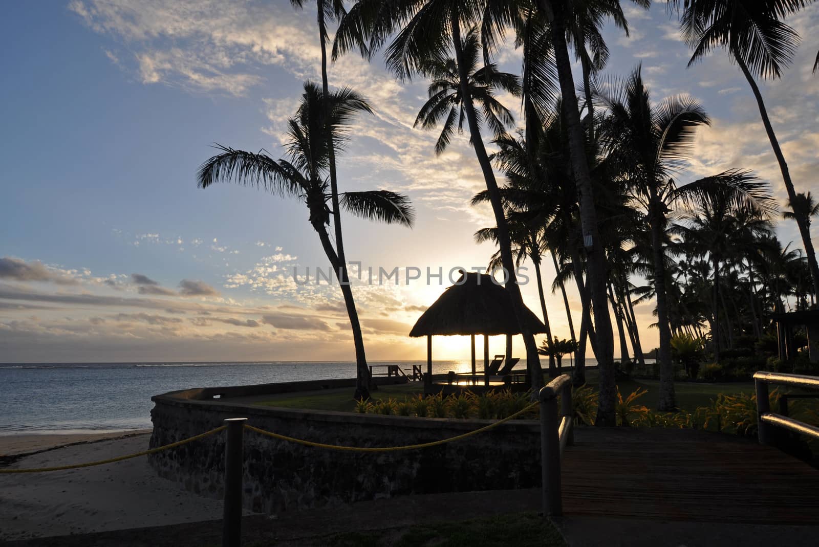 The tranquil beaches of the  South Pacific Ocean really are paradise found. This sunset is over the Coral Coast on the island of Viti Levu (Fiji)