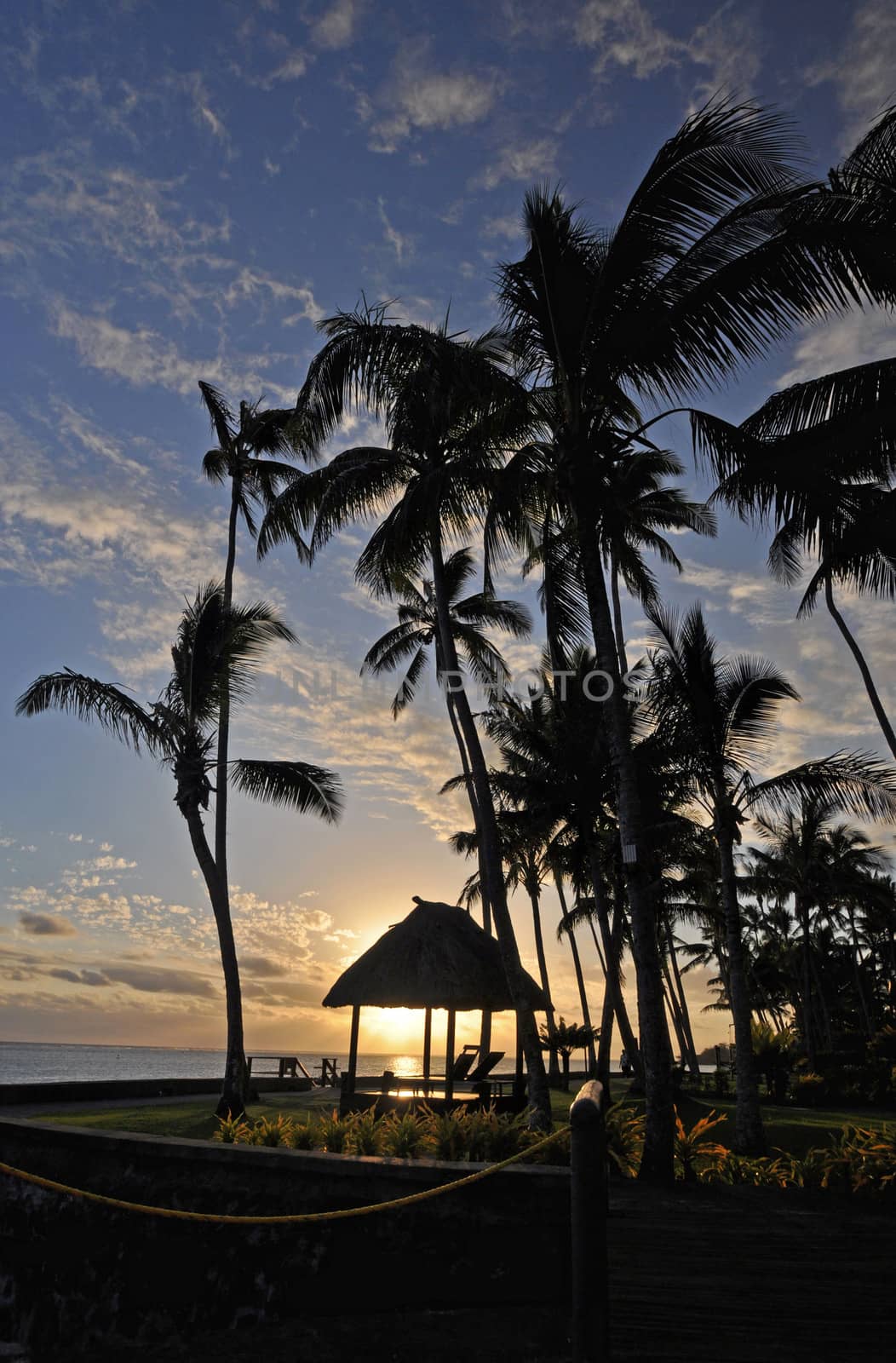 The tranquil beaches of the  South Pacific Ocean really are paradise found. This sunset is over the Coral Coast on the island of Viti Levu (Fiji)