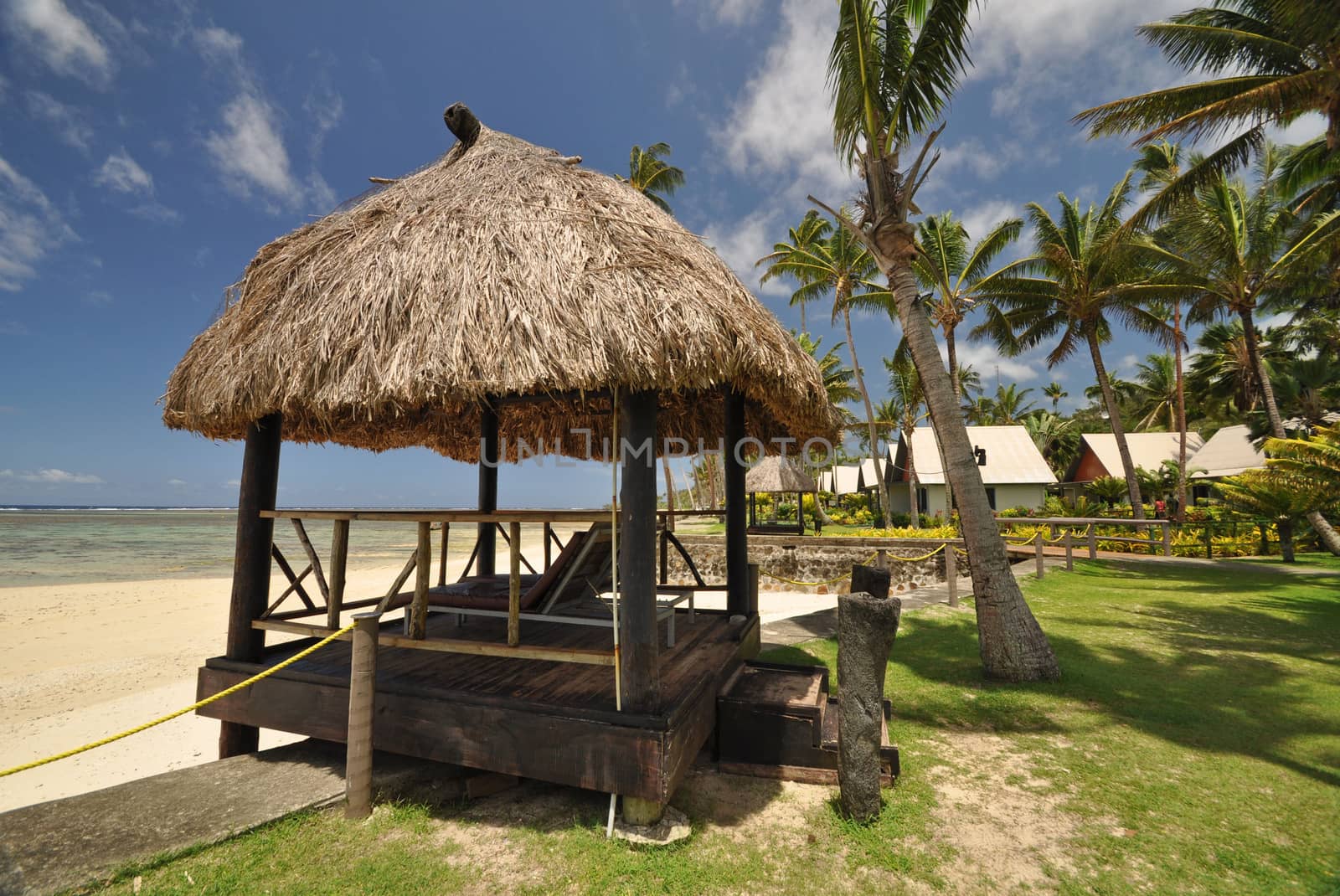 The tranquil beaches of the  South Pacific Ocean really are paradise found. This thatched beach hut overlooks the Coral Coast on the island of Viti Levu (Fiji)