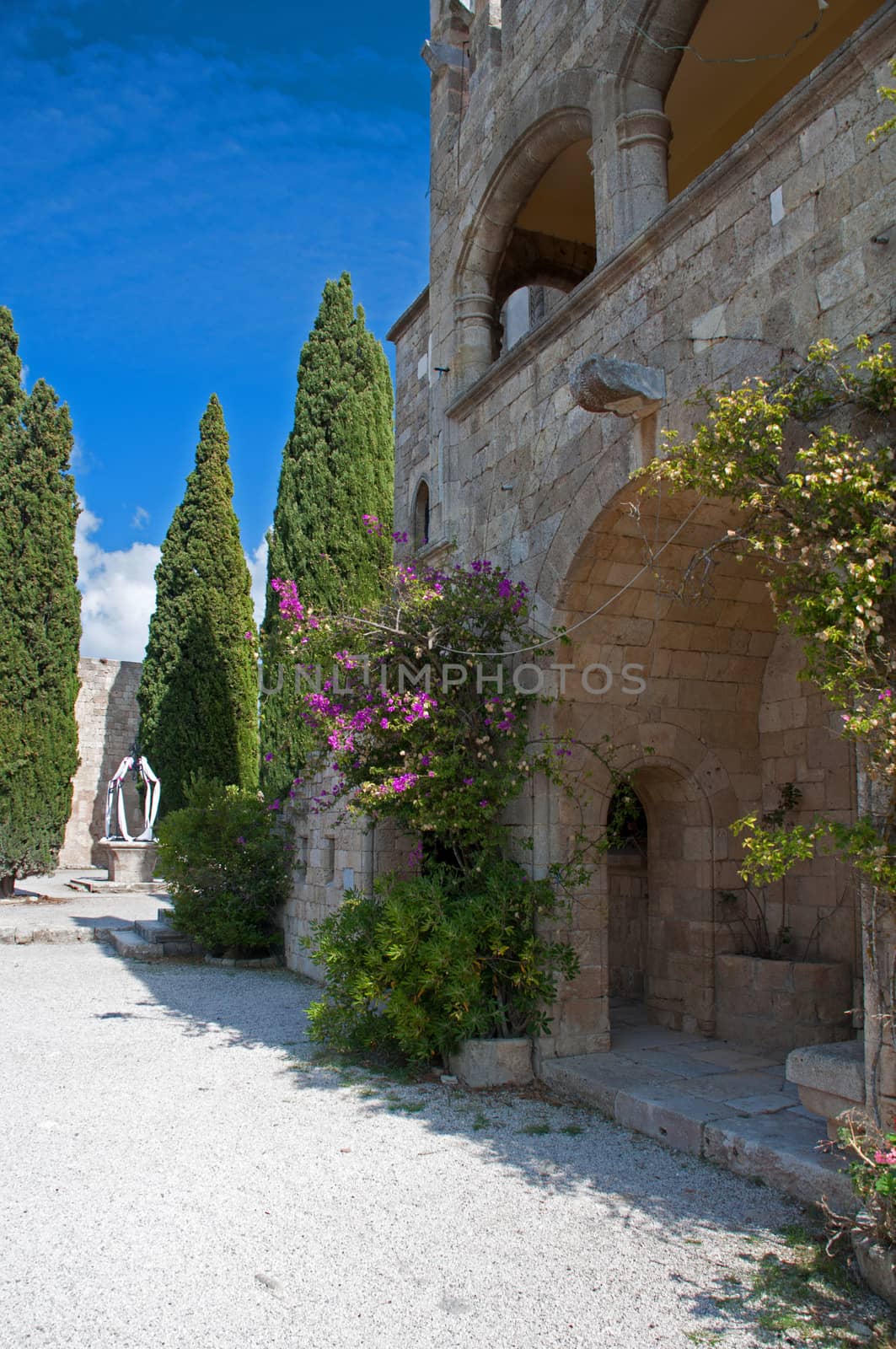 Cloisters and decorated well at Ialyssos Church by dpe123