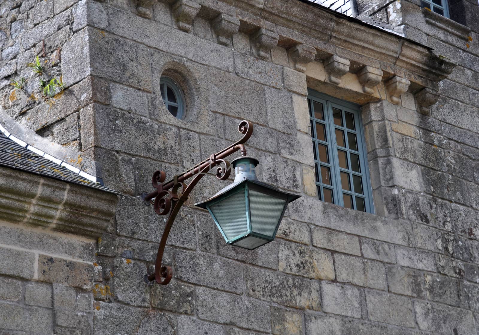 Old lamp in Locronan, Brittany, France.