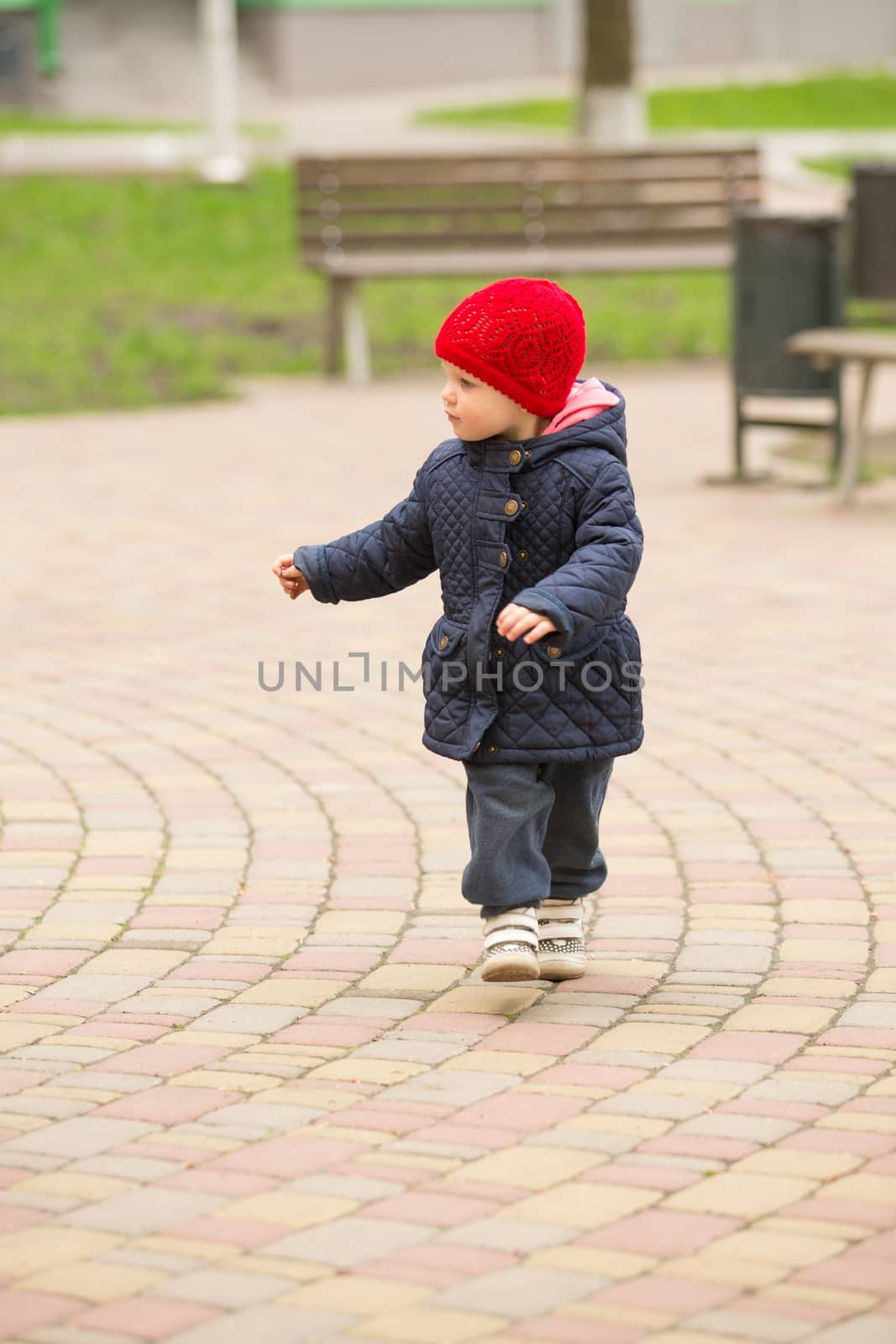 cute little girl playing in the park in spring