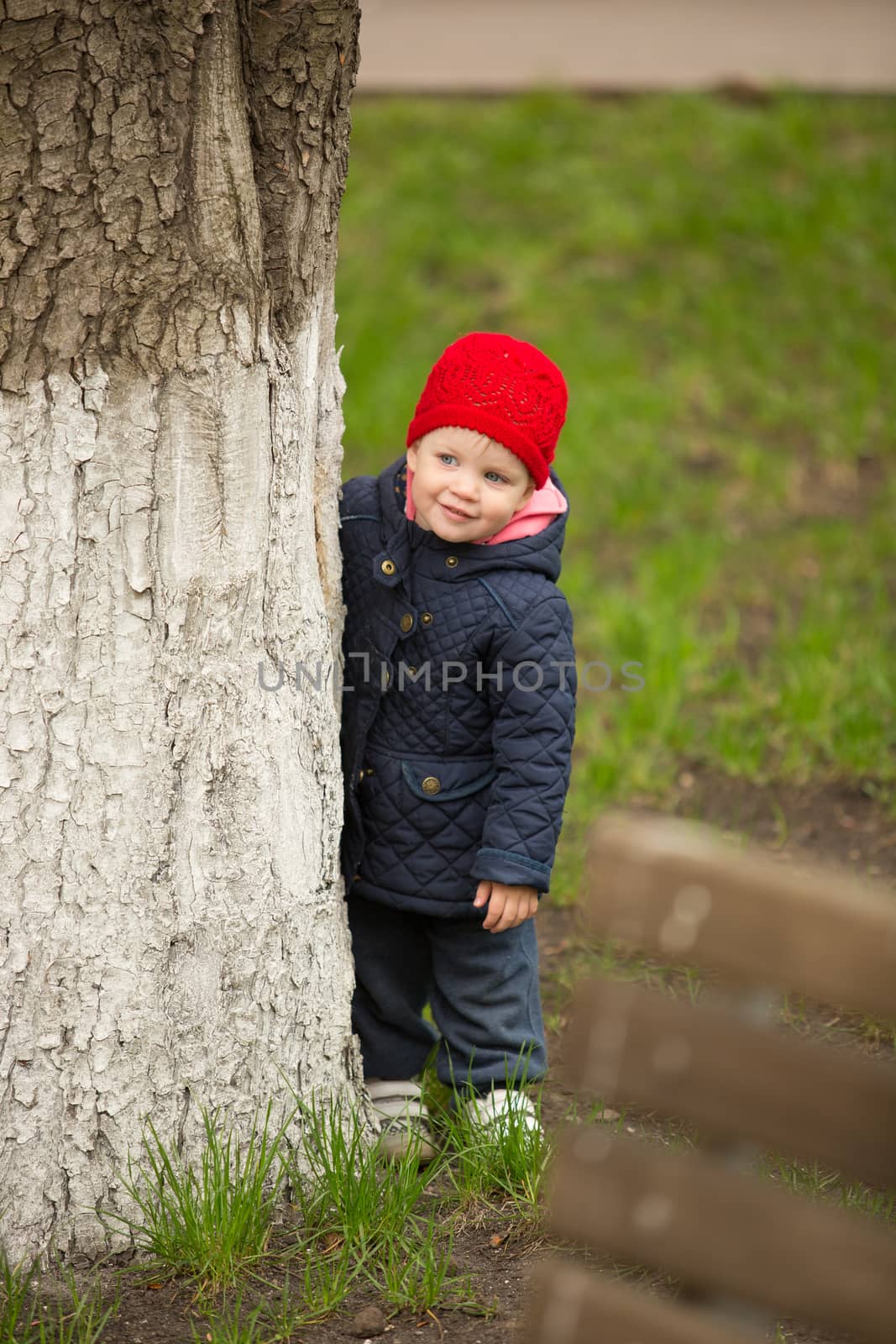 cute little girl playing in the park in spring