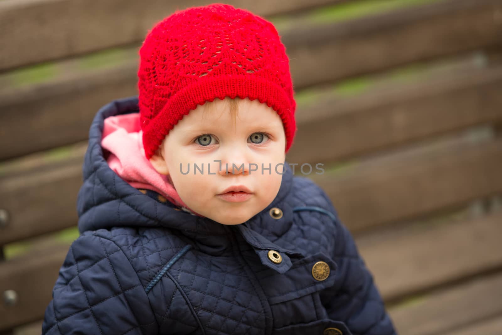 beautiful little girl in the park by sarymsakov