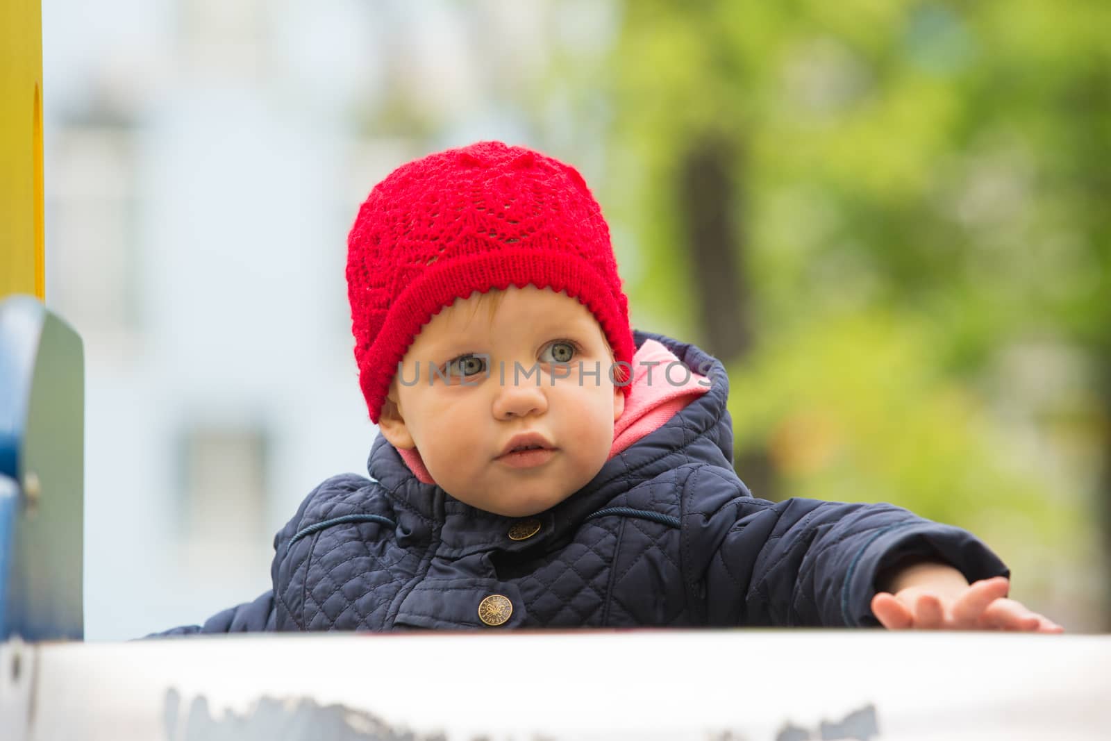 beautiful little girl in the park by sarymsakov