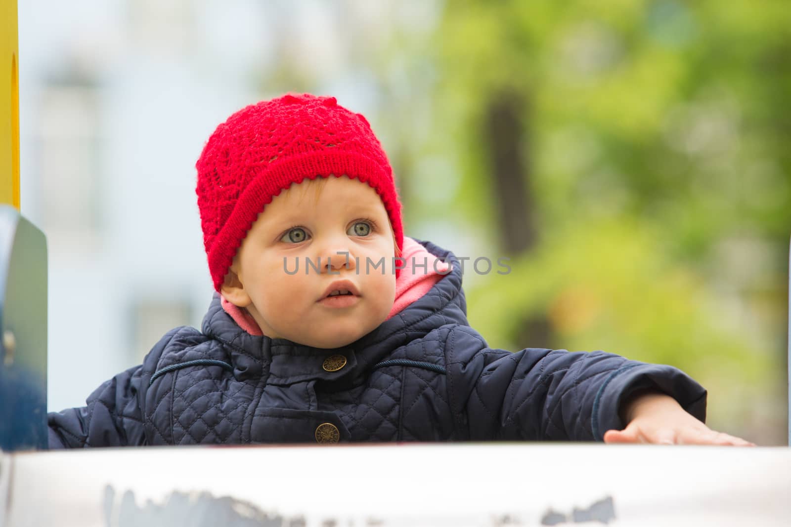 beautiful little girl in the park by sarymsakov