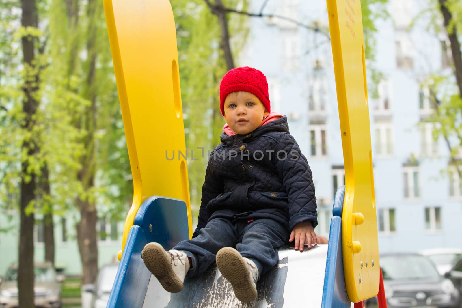 girl playing in a spring park in a playground