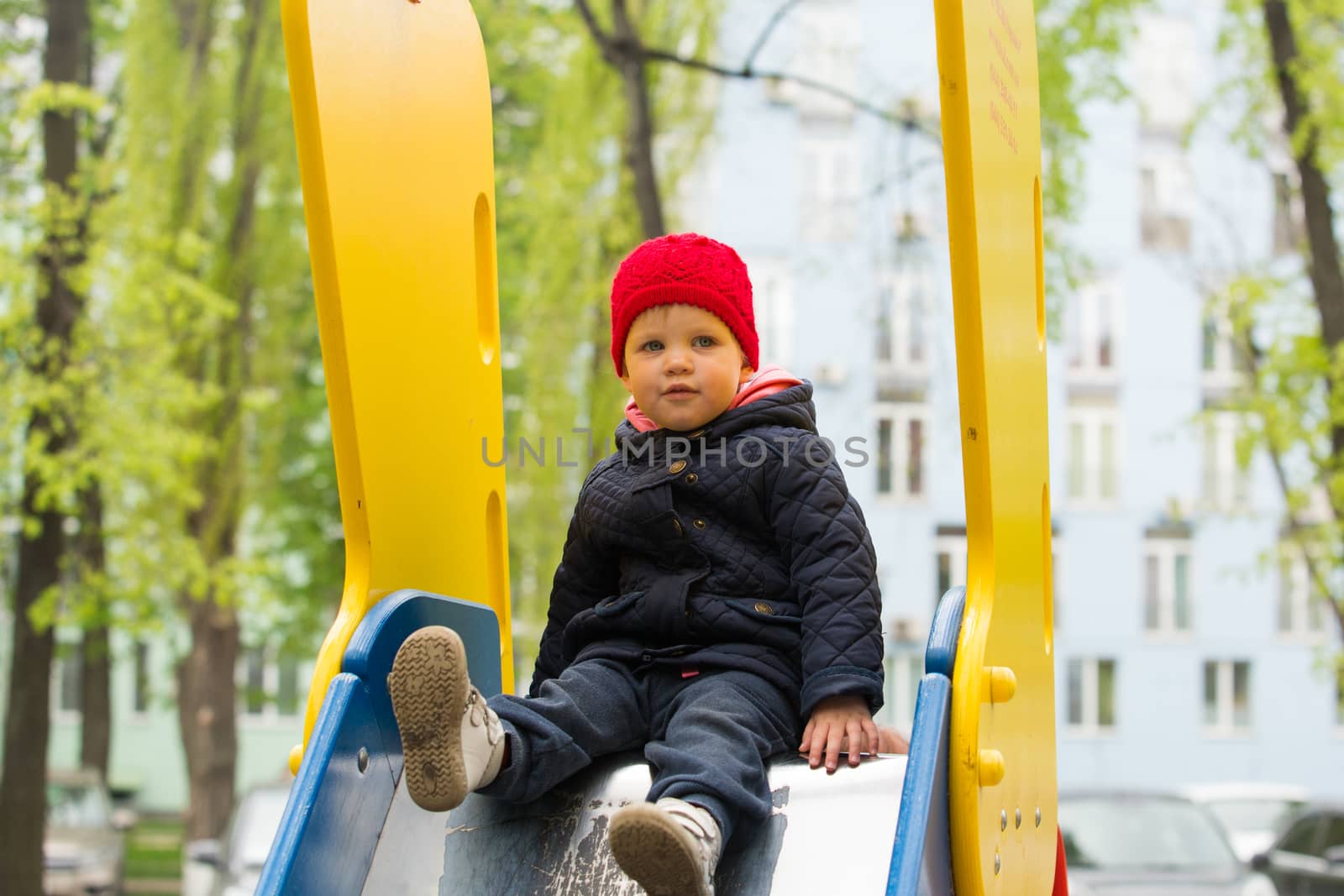 girl playing in a spring park in a playground