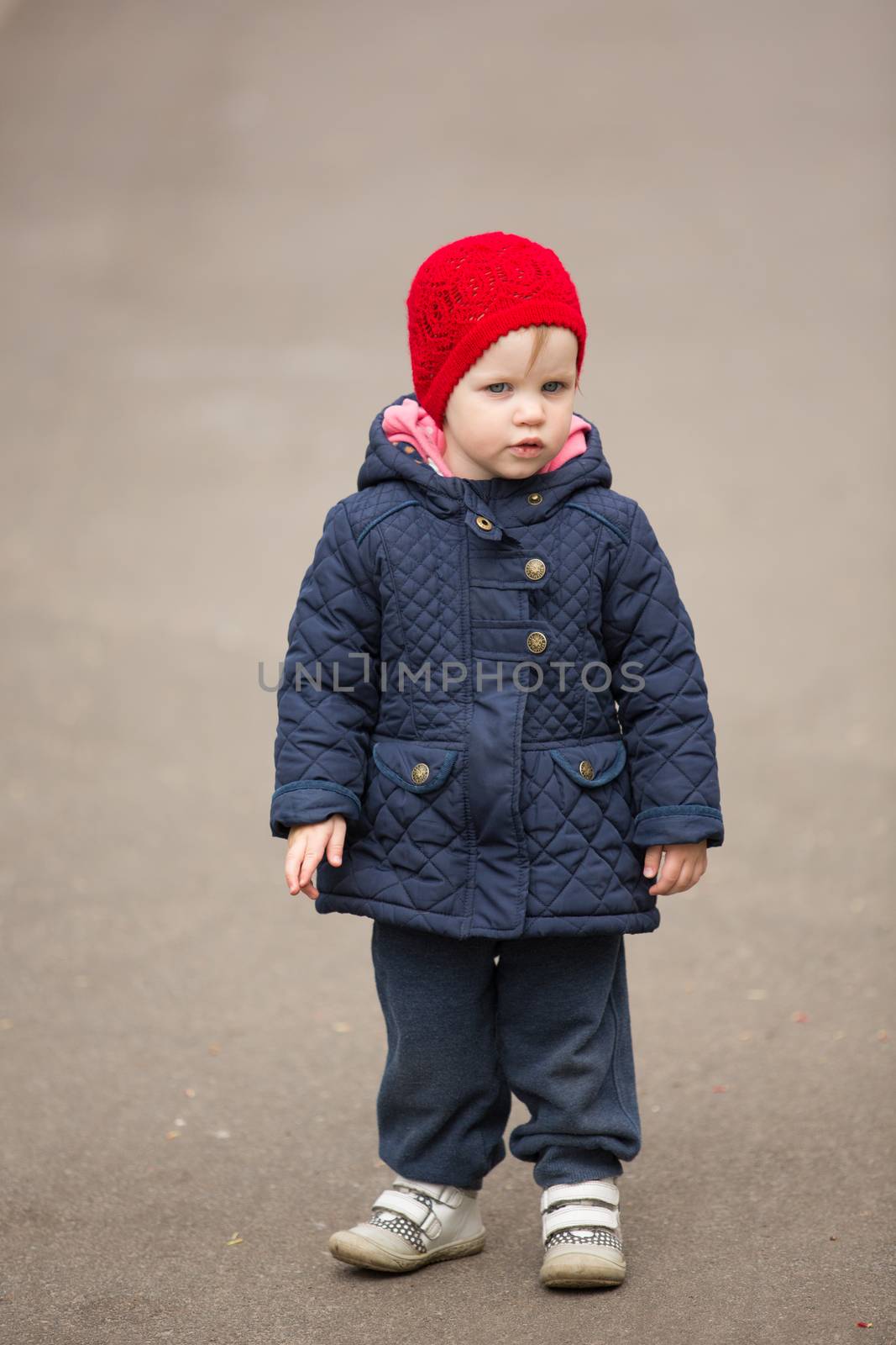 little girl on a park alley by sarymsakov