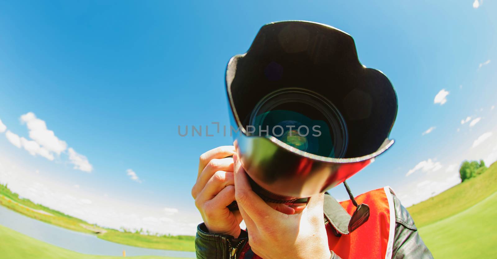 A funny fishe eye shot of a photographer at summer day