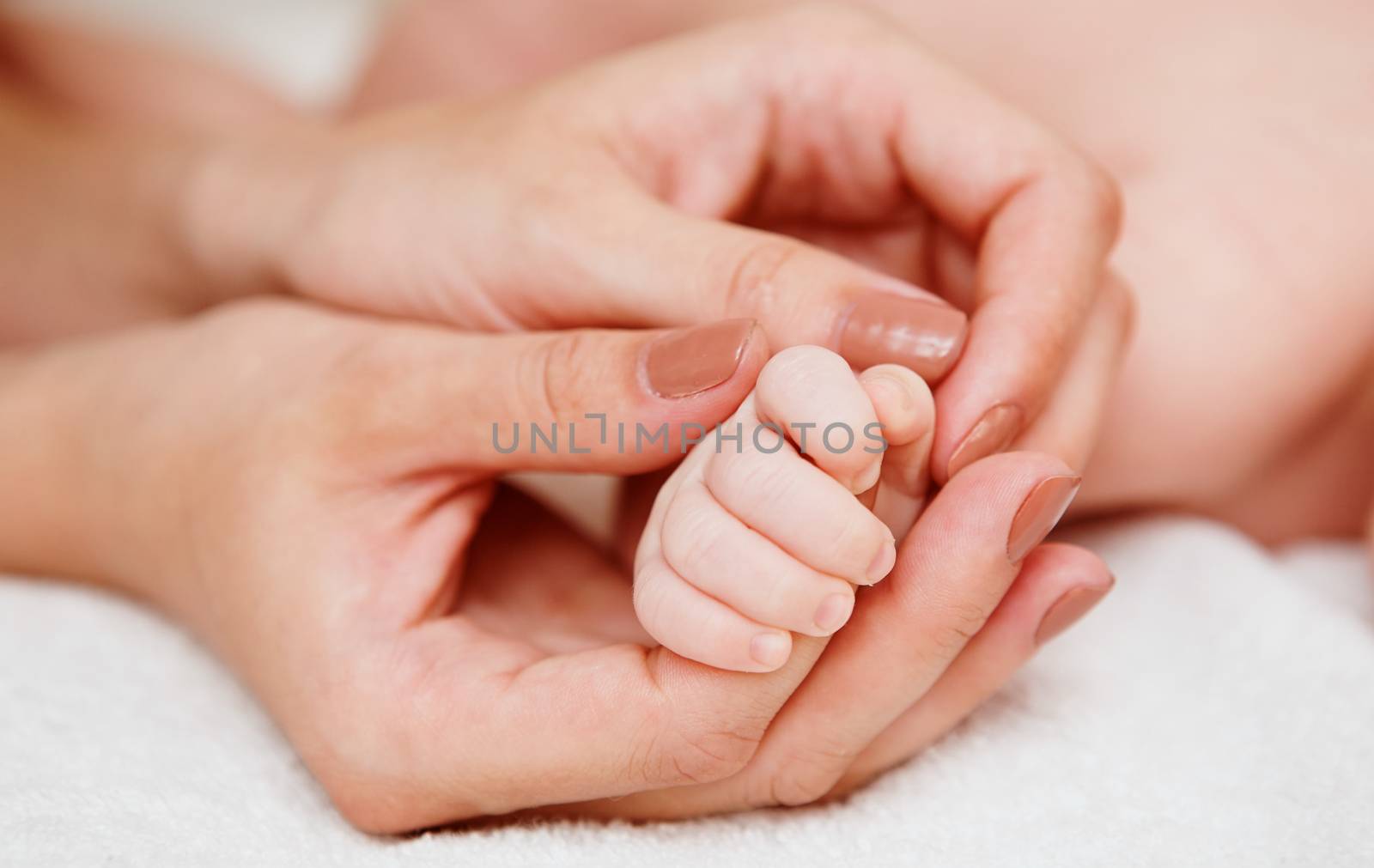 Baby holding mother finger  by sarymsakov