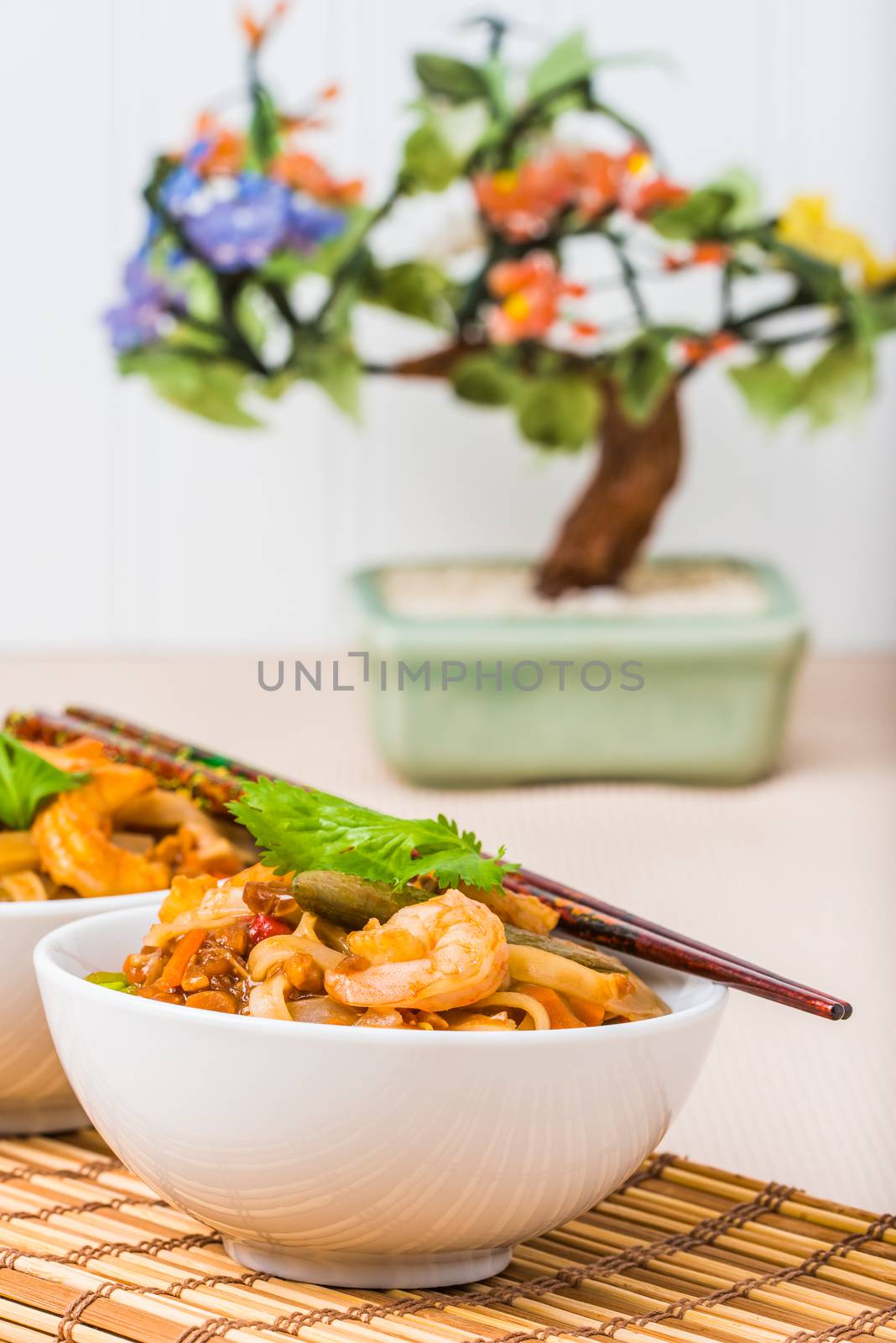 Bowls of shrimp pad thai photographed closeup.