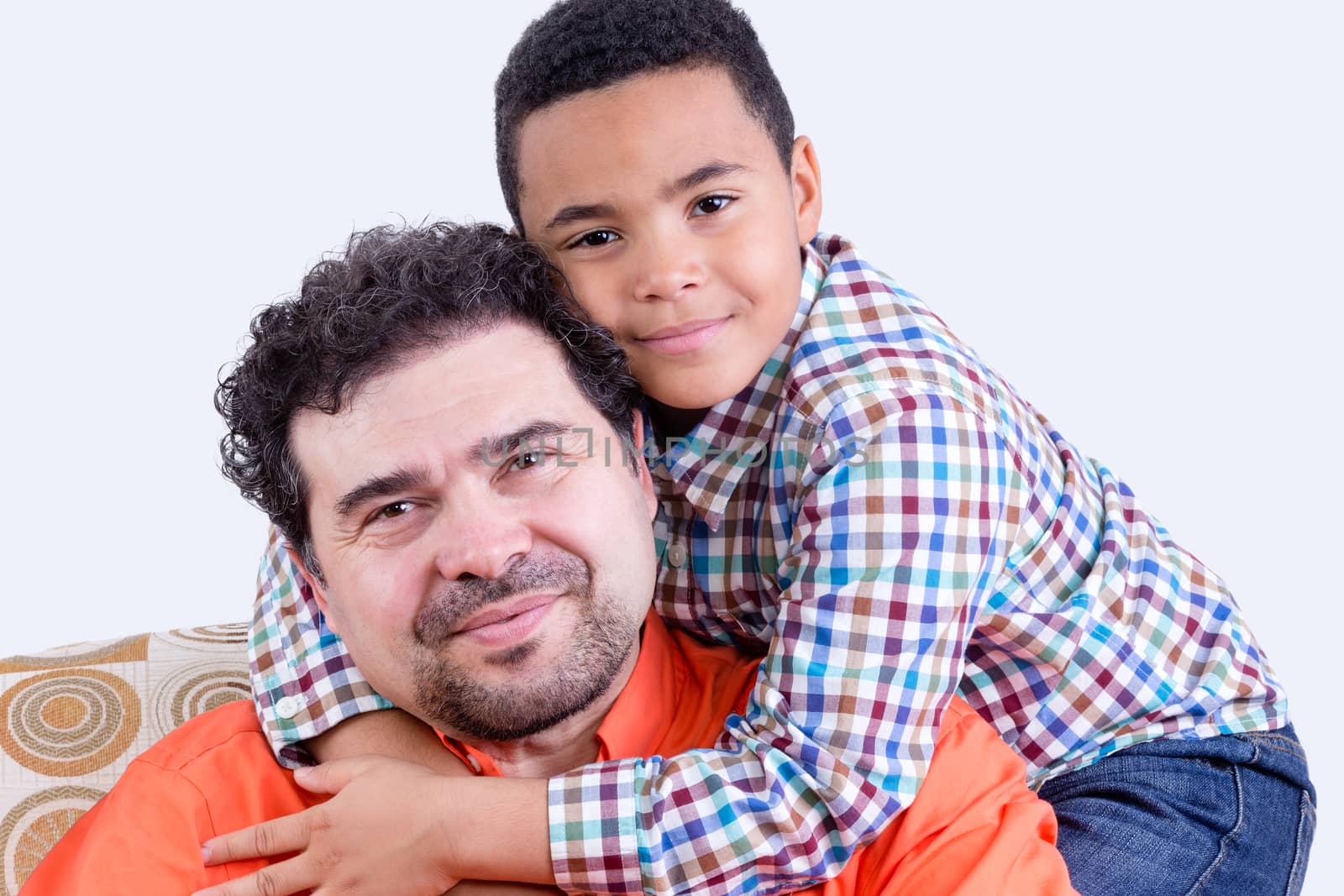 Cheerful child hugging father by coskun