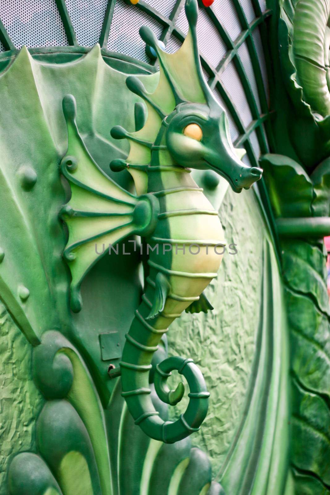 A green Seahorse statue in park