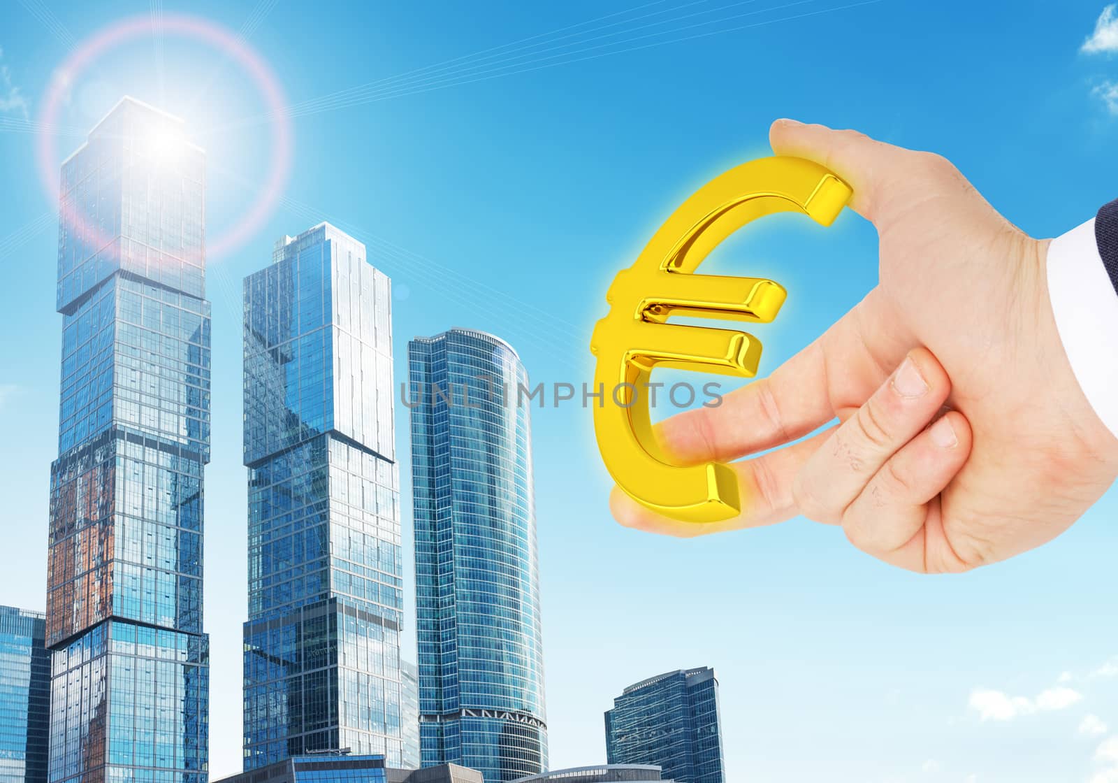 Businessman hand with euro sign on city background