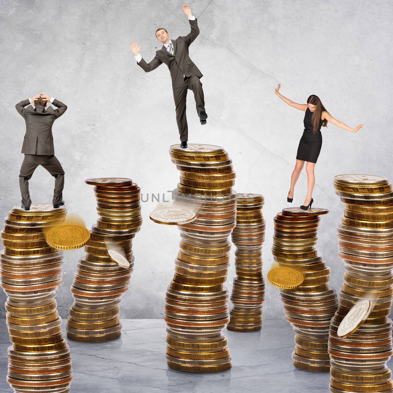 Business people standing on coins piles on grey background