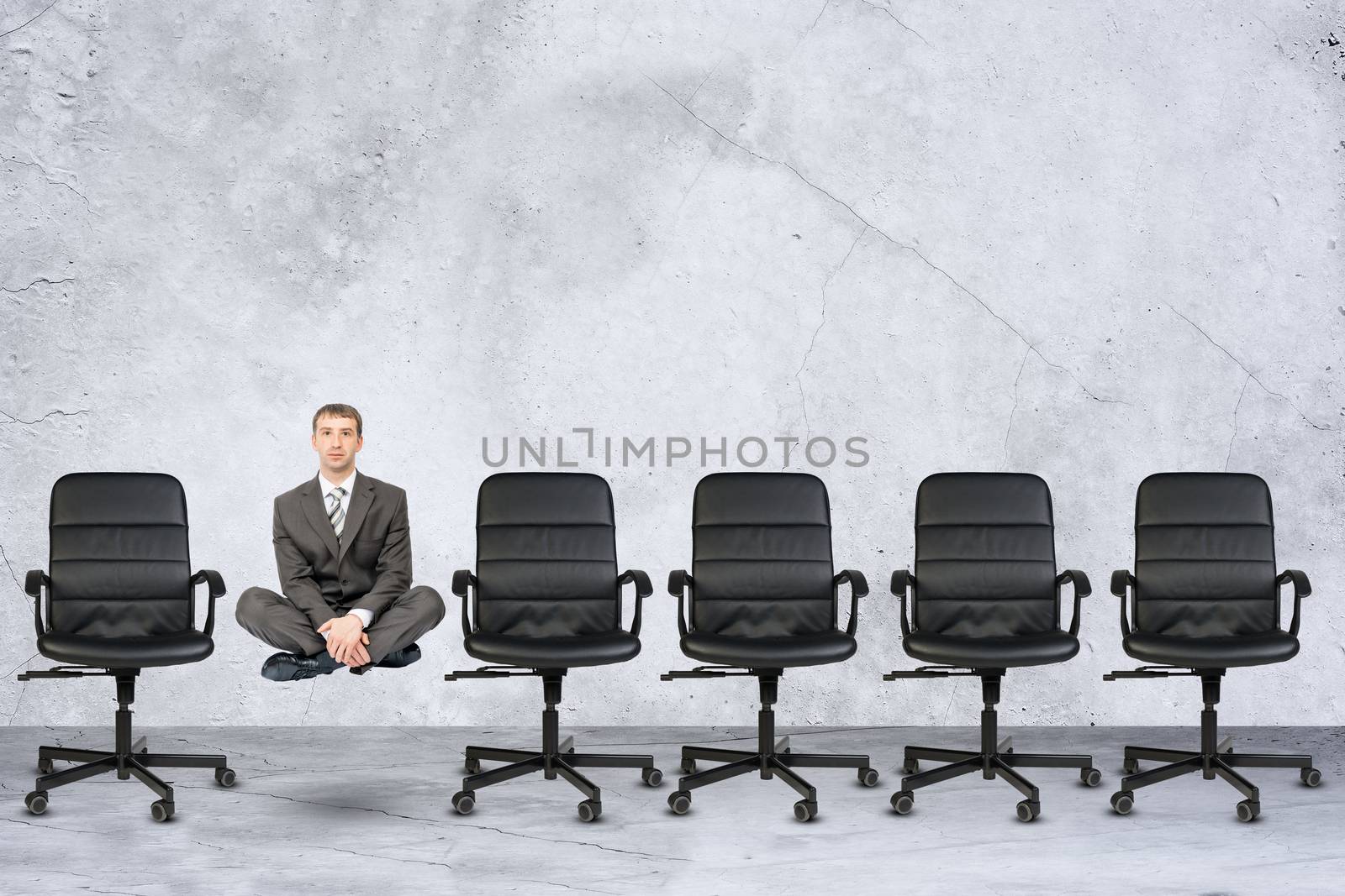 Businessman in lotus posture flying in air on grey background