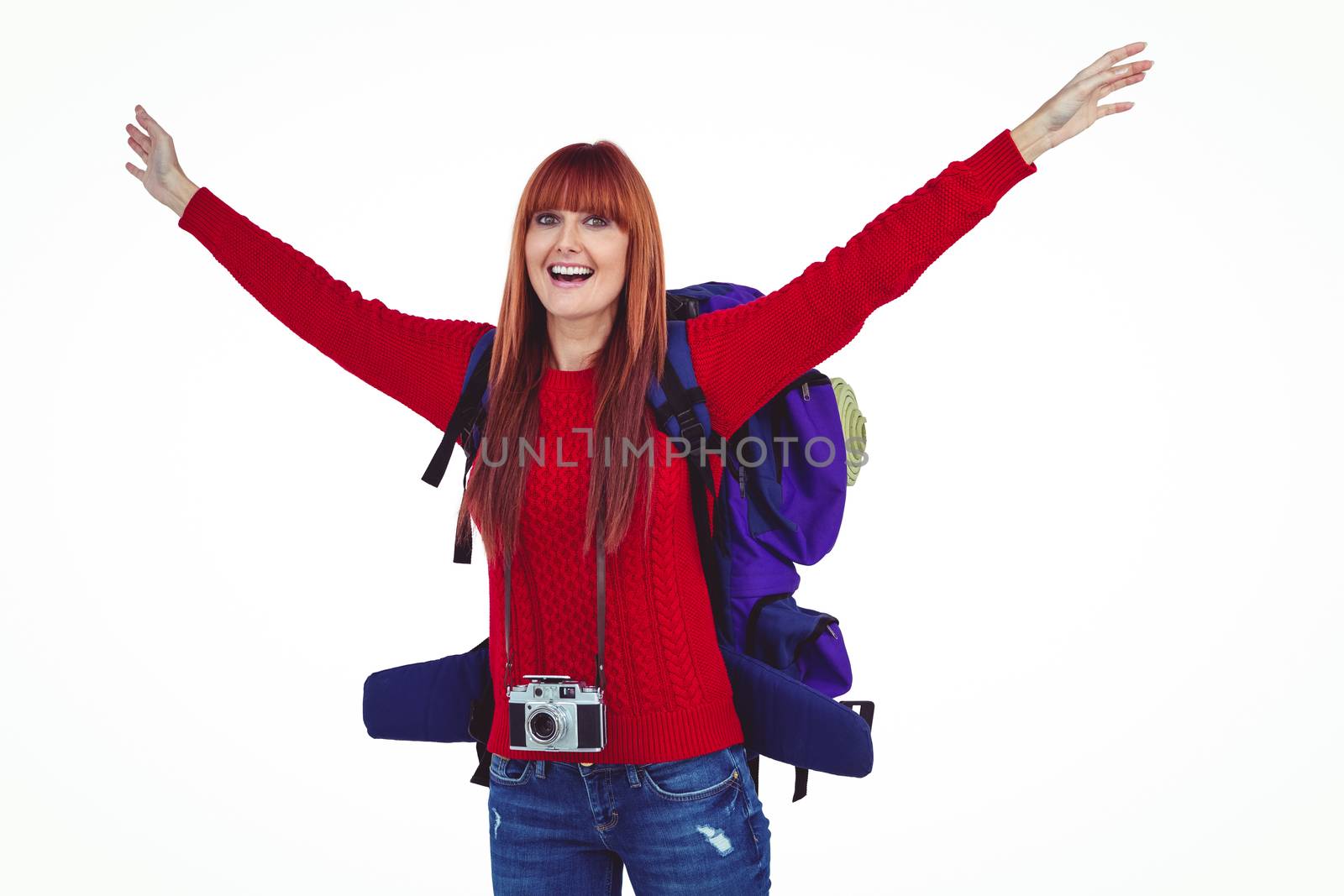 Smiling hipster woman with a travel bag against white background