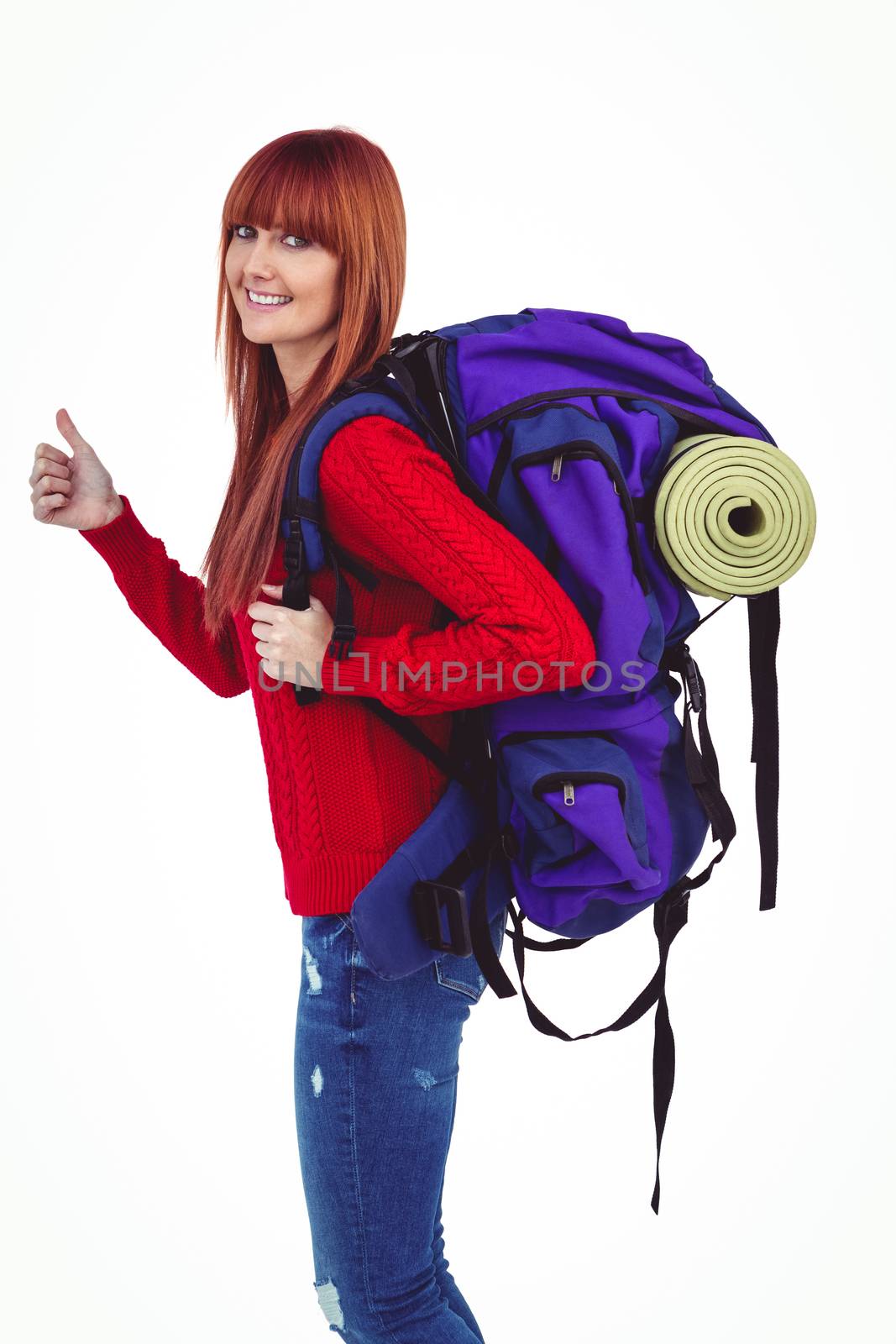 Smiling hipster woman with a travel bag on her back