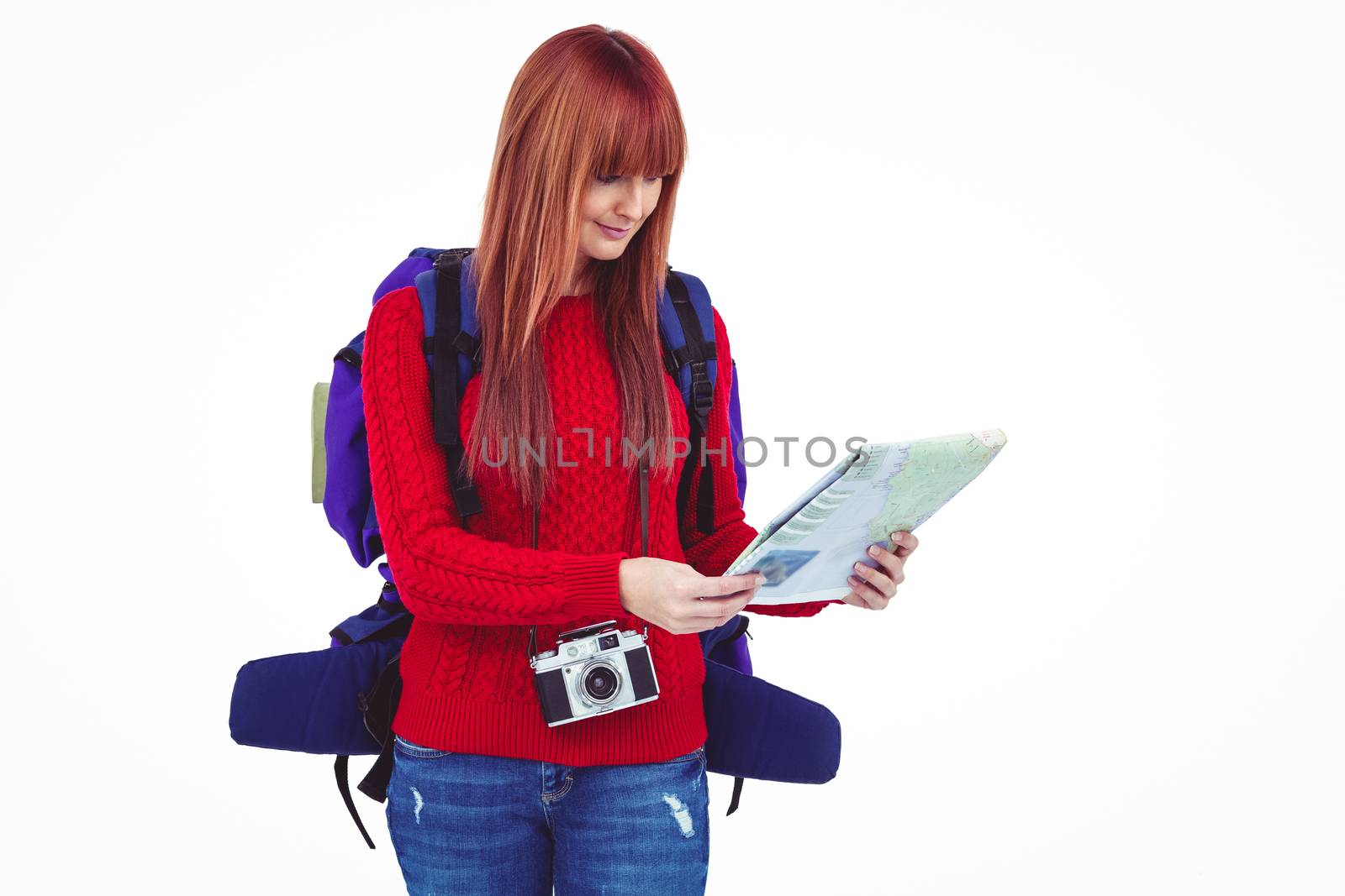 Smiling hipster woman with a travel bag with a map against white background