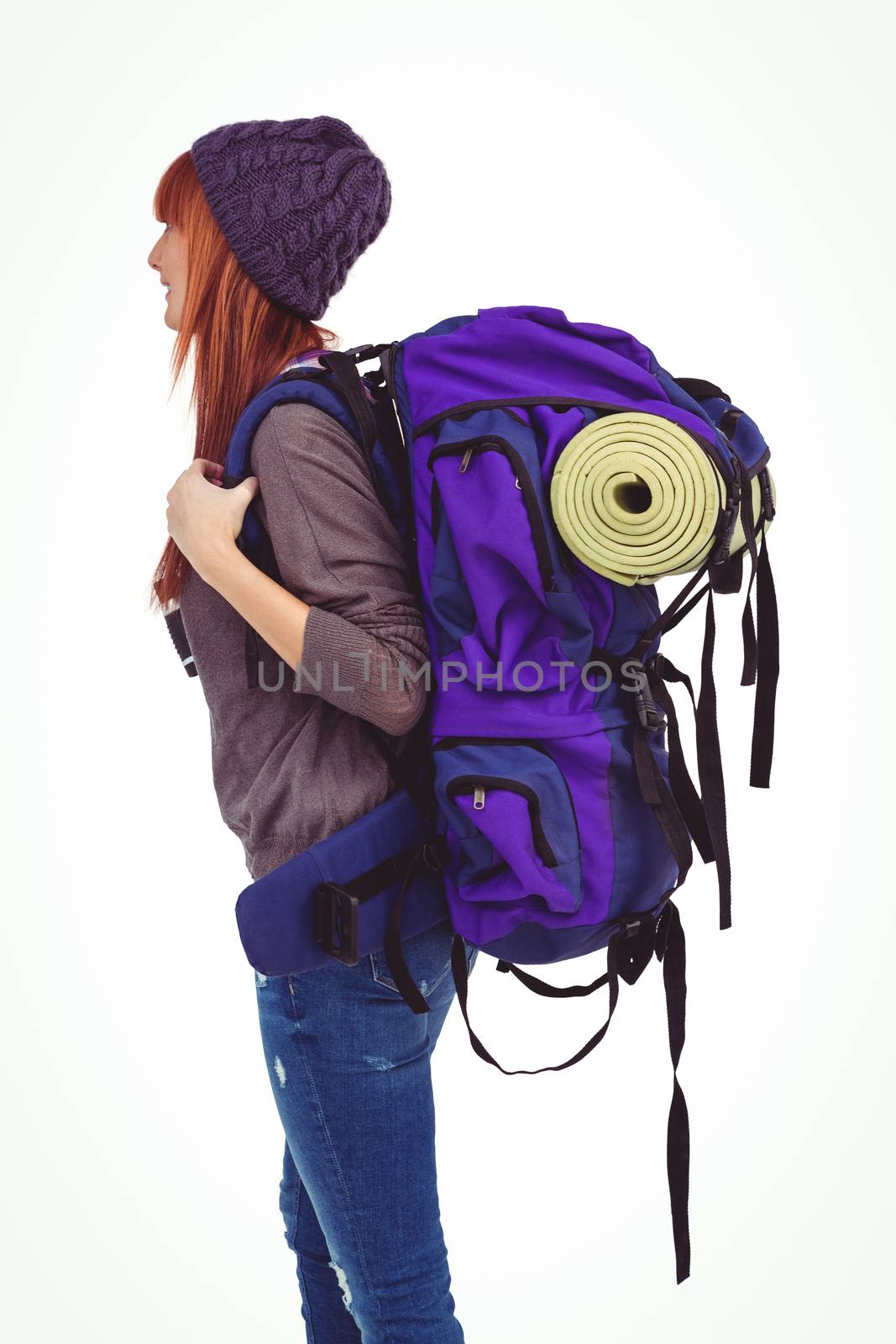 Side view of a hipster woman with a travel bag against white background