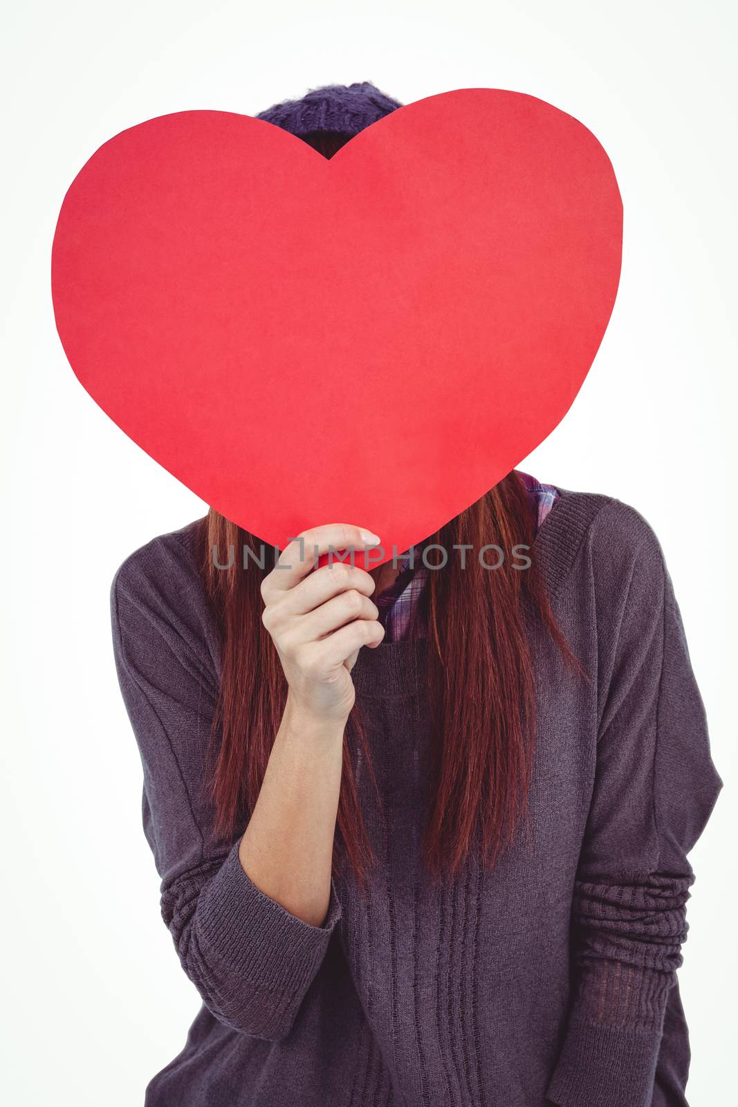 Hipster woman behind a red heart against white background