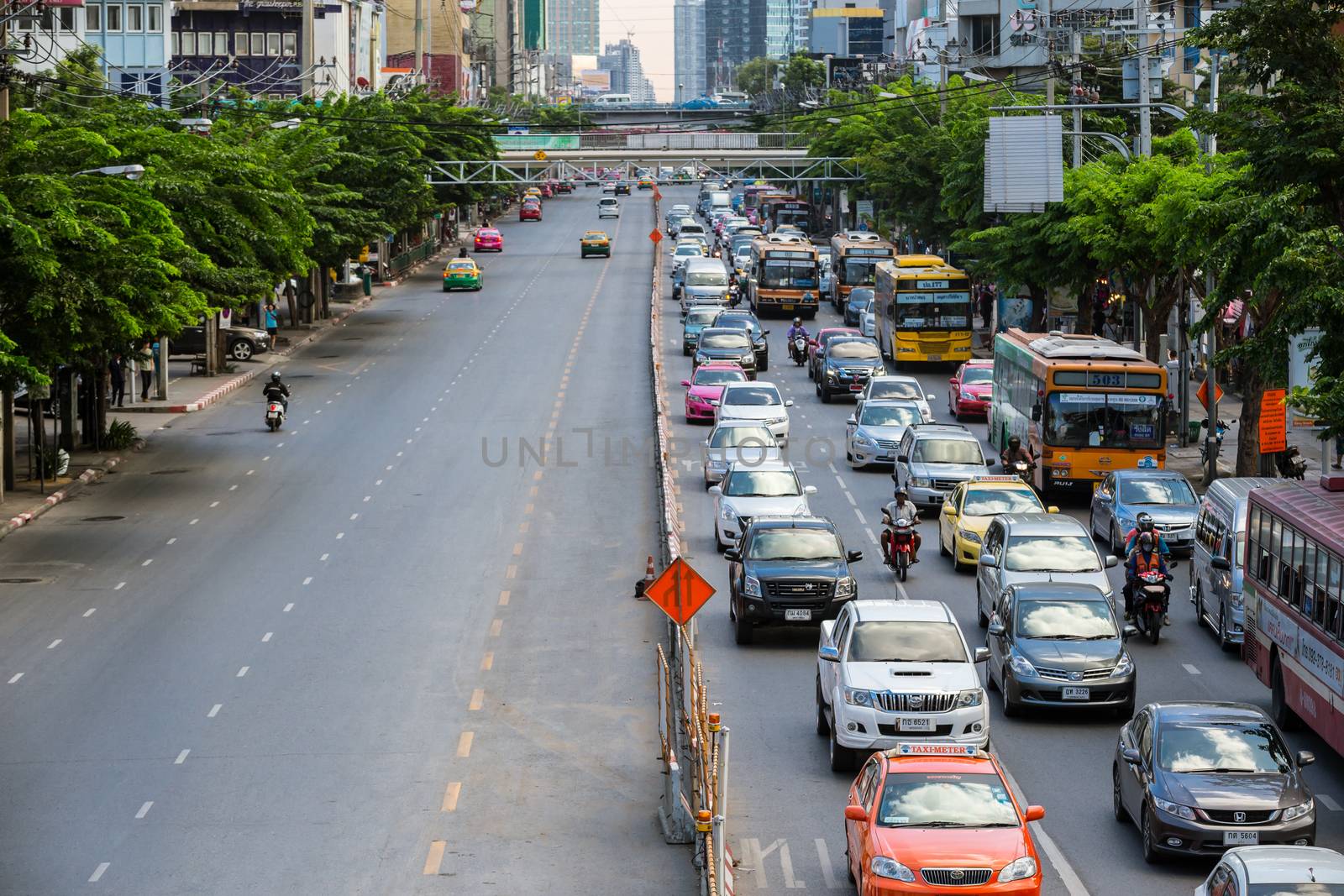 Bangkok, Thailand - November 22, 2015: Heavy traffic jams cause by the construction of the BTS skytrain on the Phahonyothin Road in rush hours on the right side compare to left side that has less traffics in Bangkok, Thailand