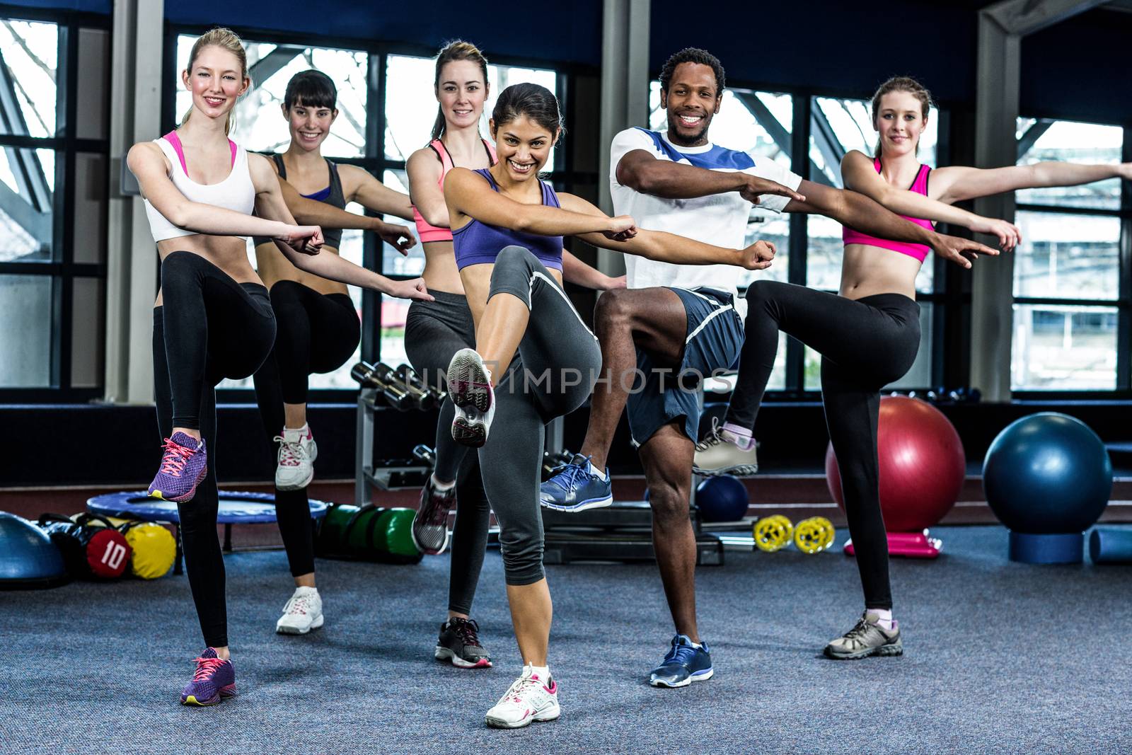 Fit smiling group doing exercise by Wavebreakmedia