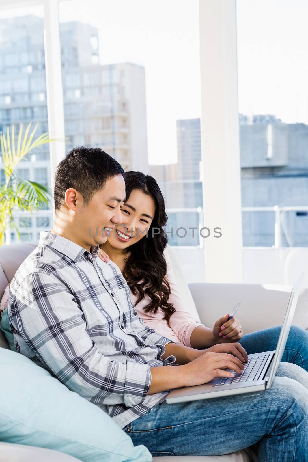 Man and woman using laptop at home 