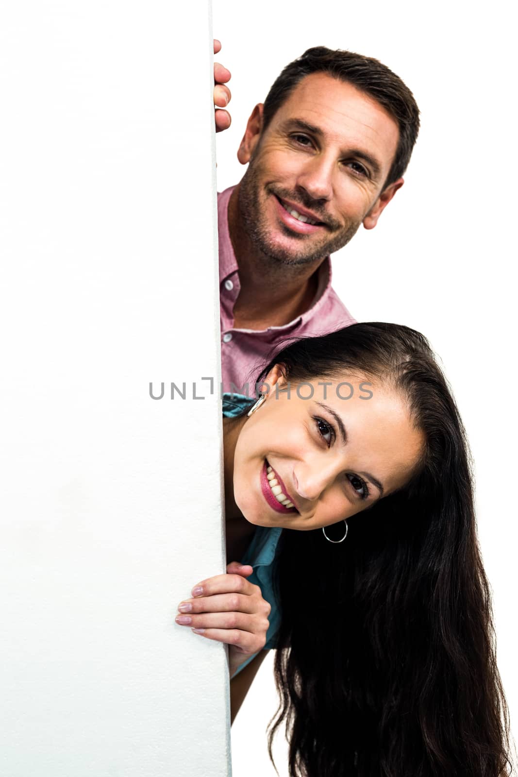 Smiling couple posing for camera on white screen