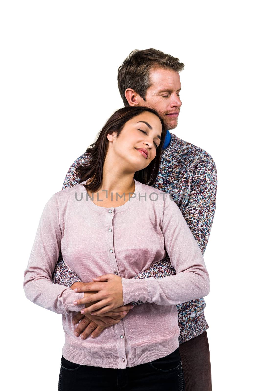 Close-up of romantic couple hugging against white background