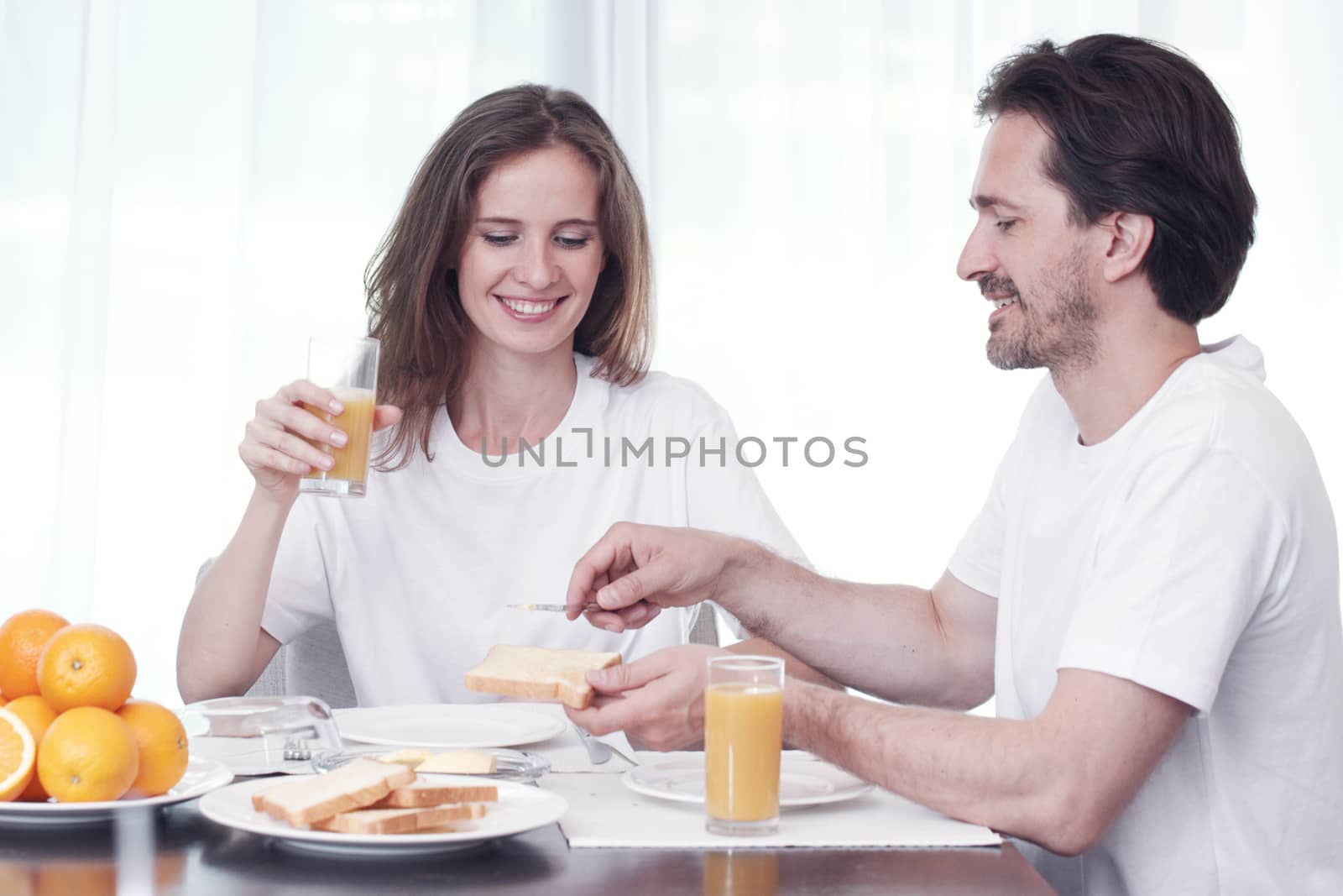 Couple having breakfast together at home 