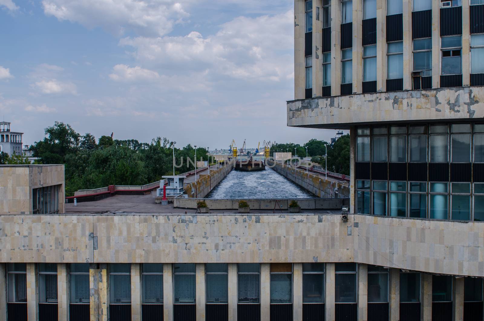 a cargo barge in the lock of a water dam