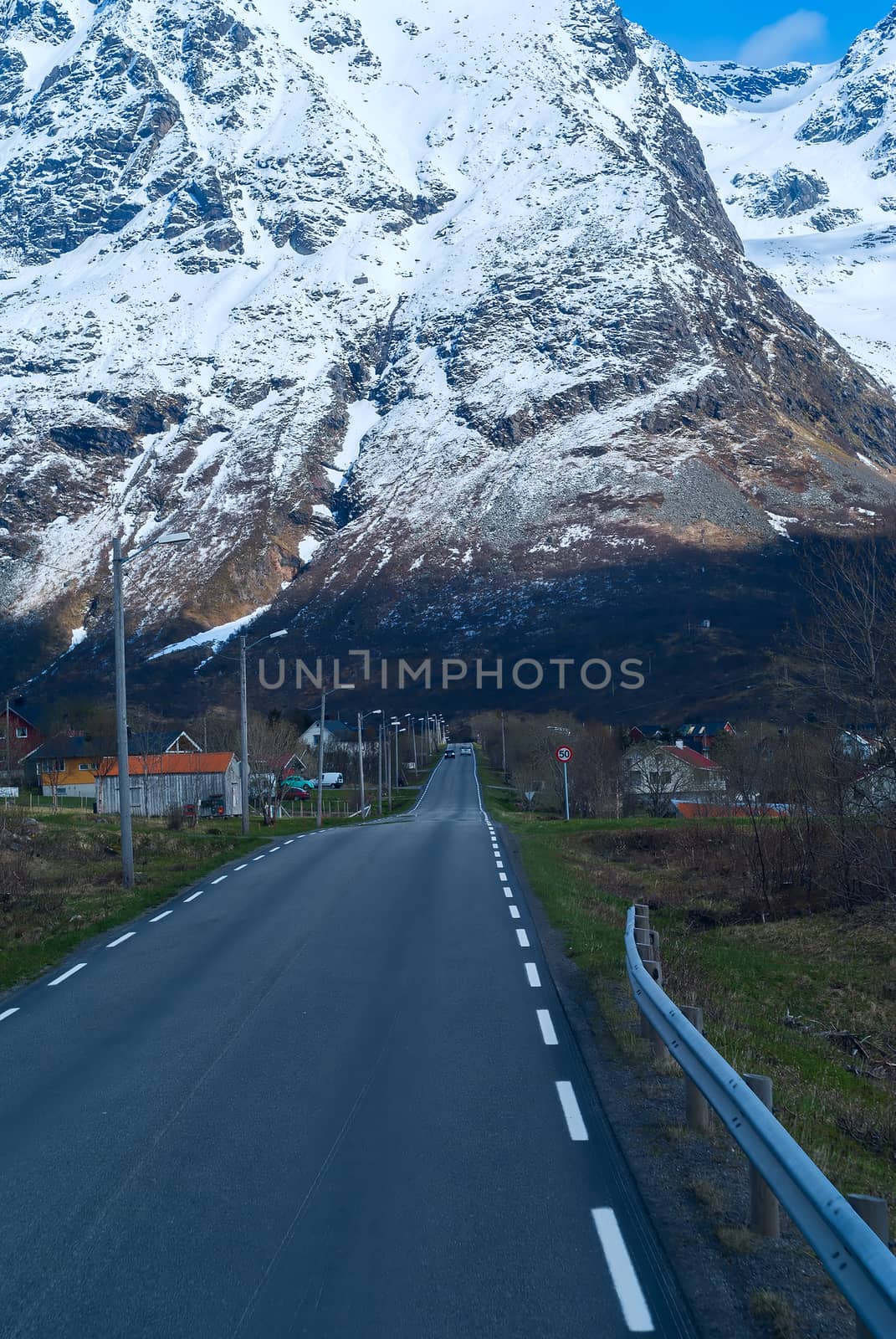 Asphalt road in Norvegian snowbound mountains 