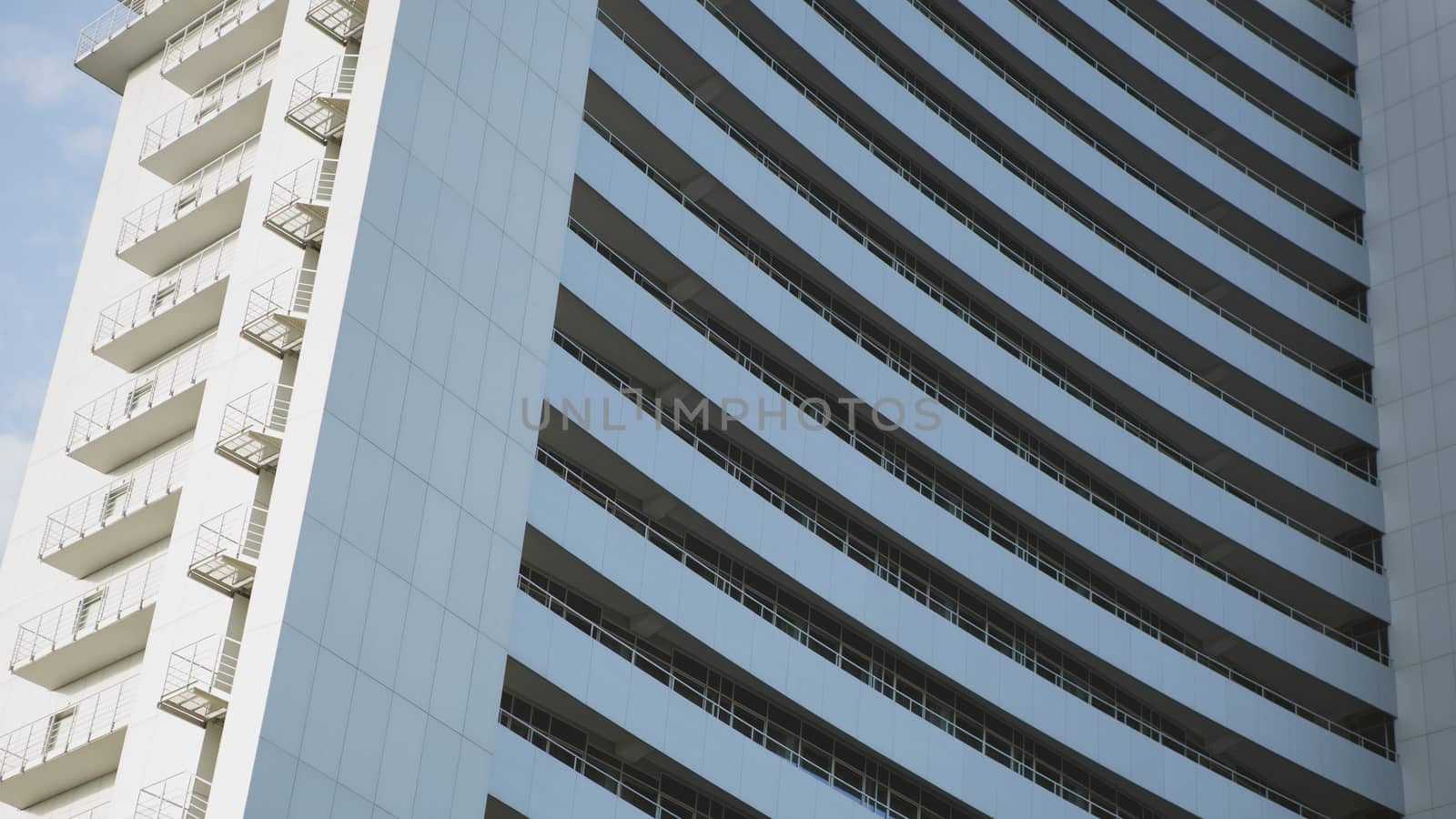 Perspective and underside angle view to textured background of modern glass building 