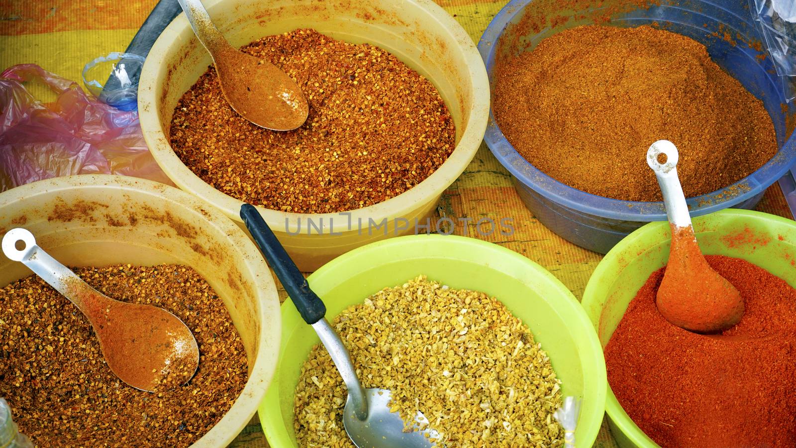 colorful chili powder and spice in the bucket at fresh local market in Luang Prabang, Laos