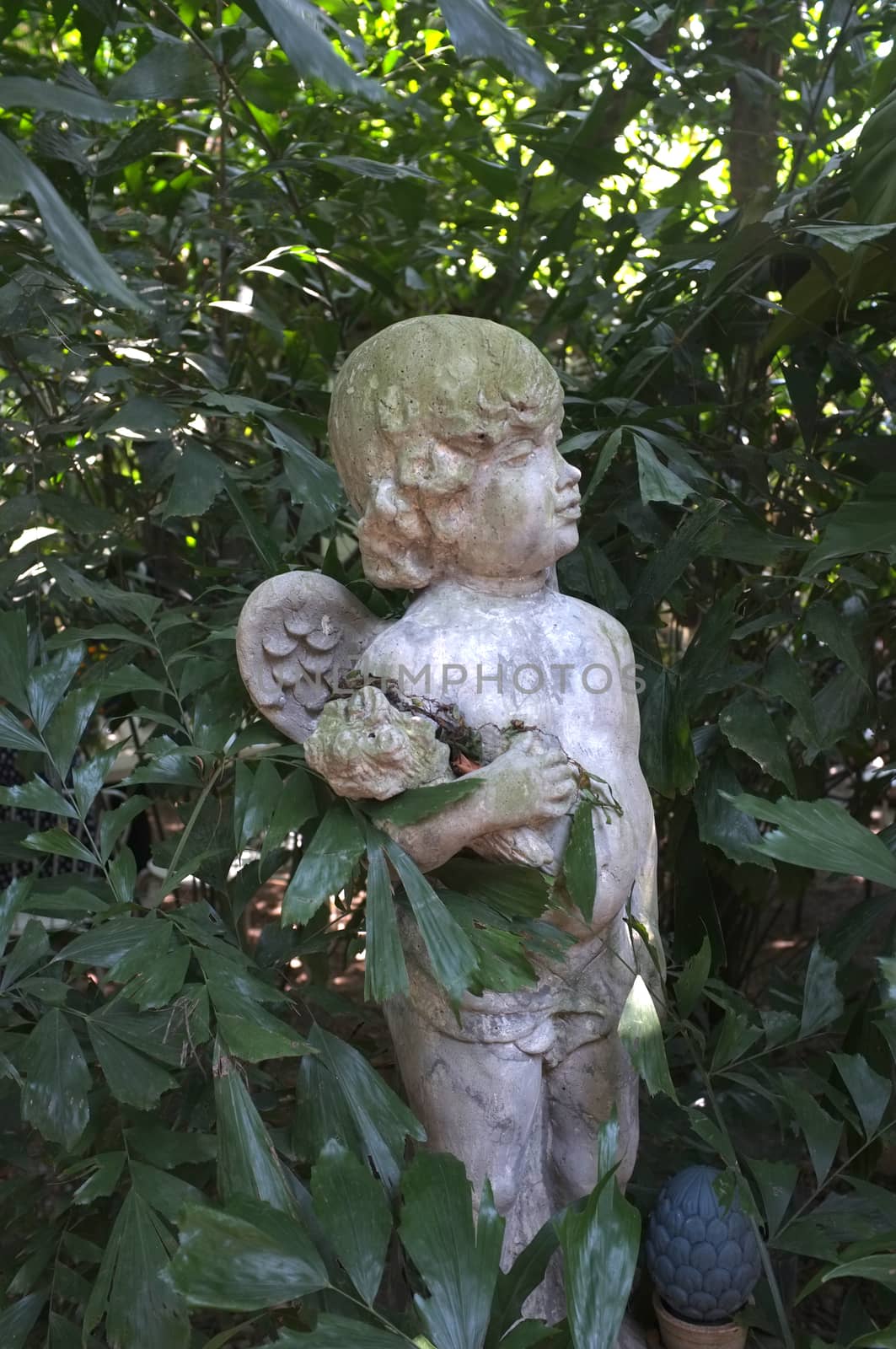 Sculpture covered with moss in garden